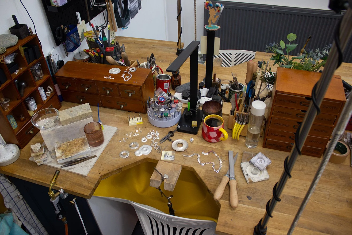 Jewellery bench with tools and work in progress in a Glasgow studio.