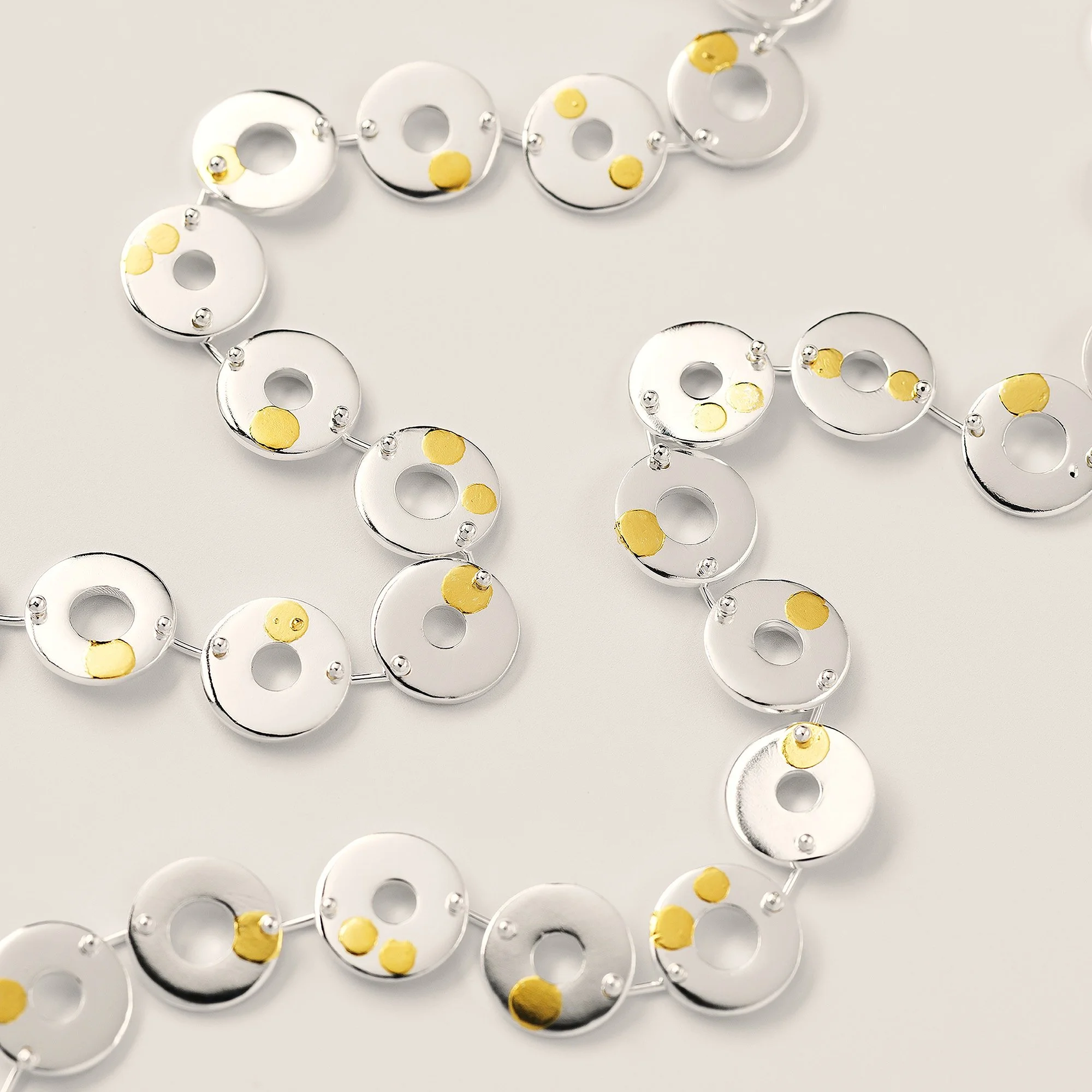 Sterling silver Kairoi necklace with flat torus links and 24ct gold dotted detailing