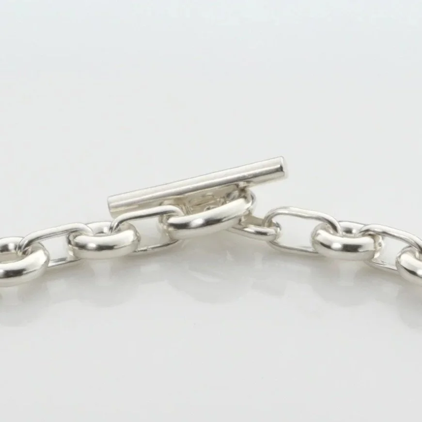 Close-up of Monad Link necklace showing hand-drawn wire torus links and T-bar clasp