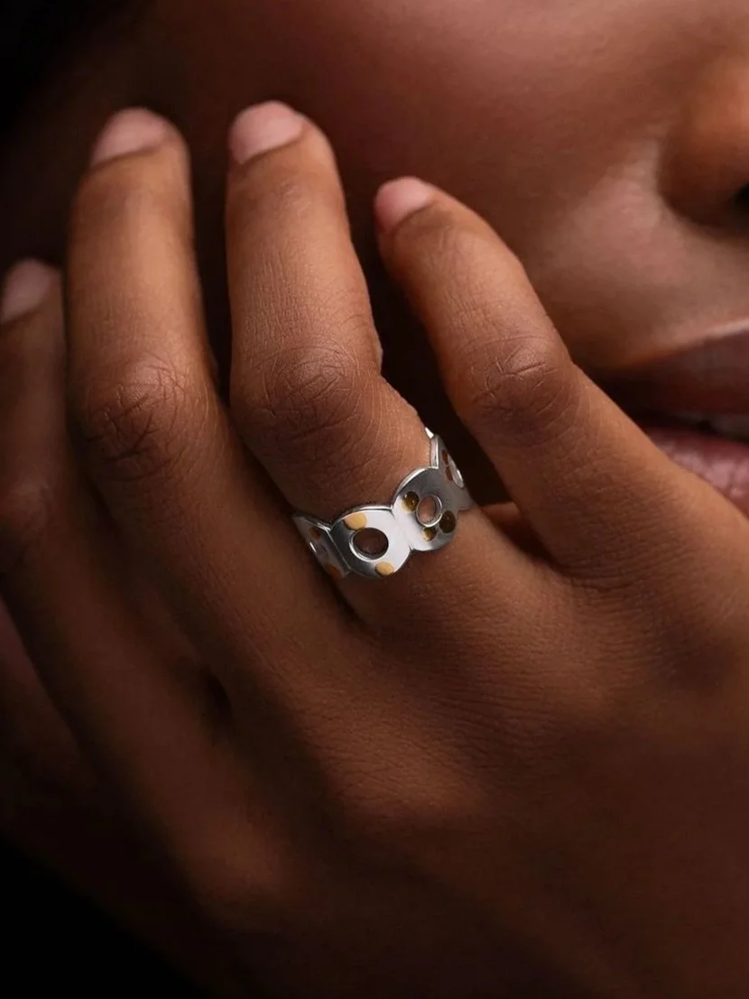 Close-up of hand wearing Kairoi open ring, flat torus form with gold dotted detailing