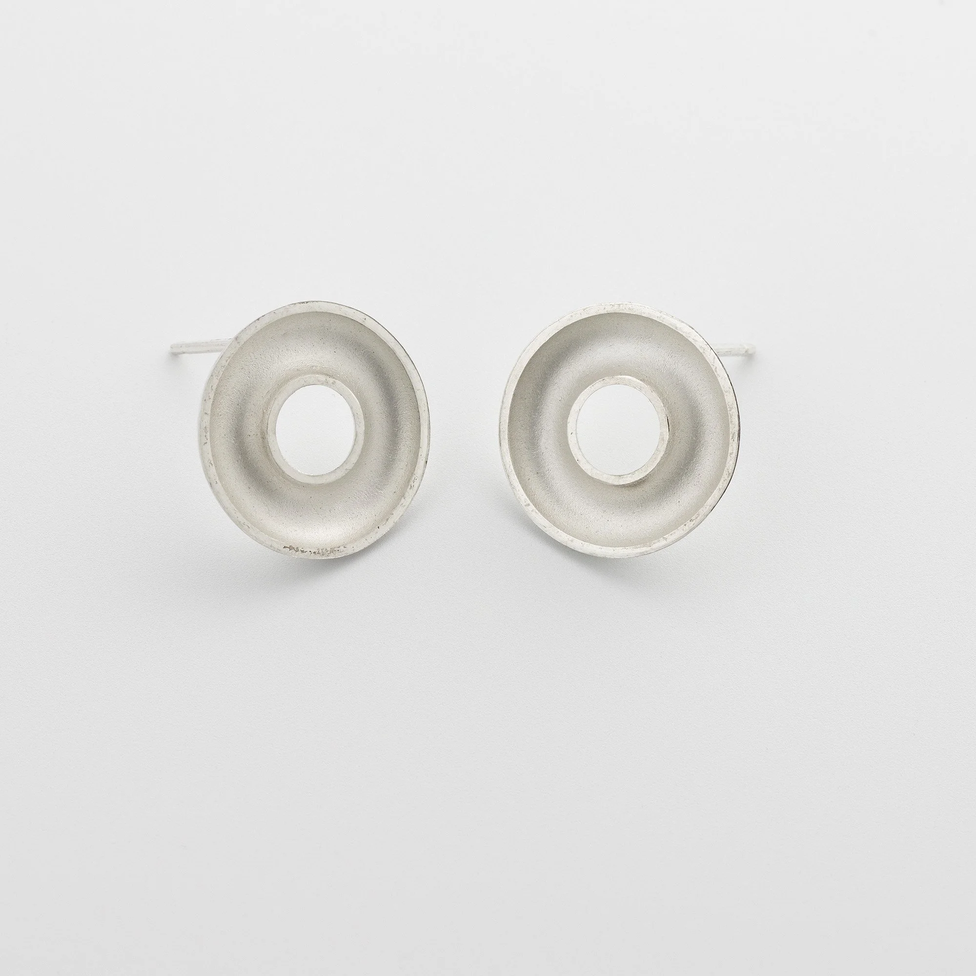 Sterling silver Orbis small stud earrings, circular, concave torus form, polished edge and white interior