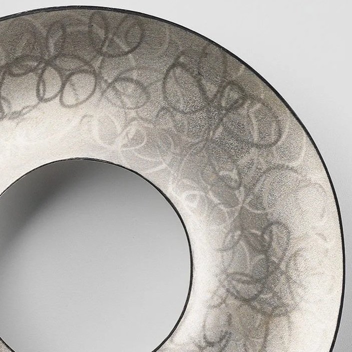 Close-up of Loop the Loop brooch showing fine looped pattern and shimmering surface