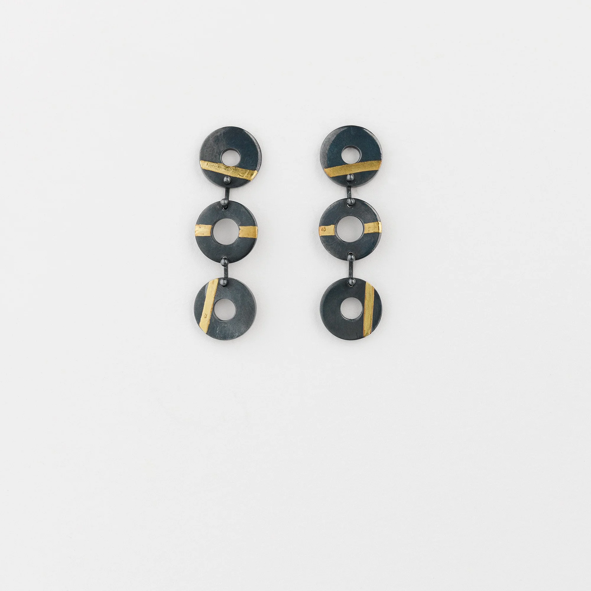Oxidised sterling silver Chronos trio earrings, three linked flat torus shapes with 24ct gold stripes