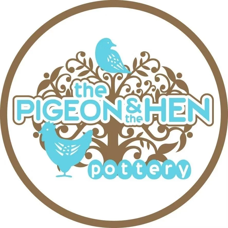 Logo for The Pigeon and the Hen Pottery featuring a tree with two blue birds and stylized text in brown and blue.