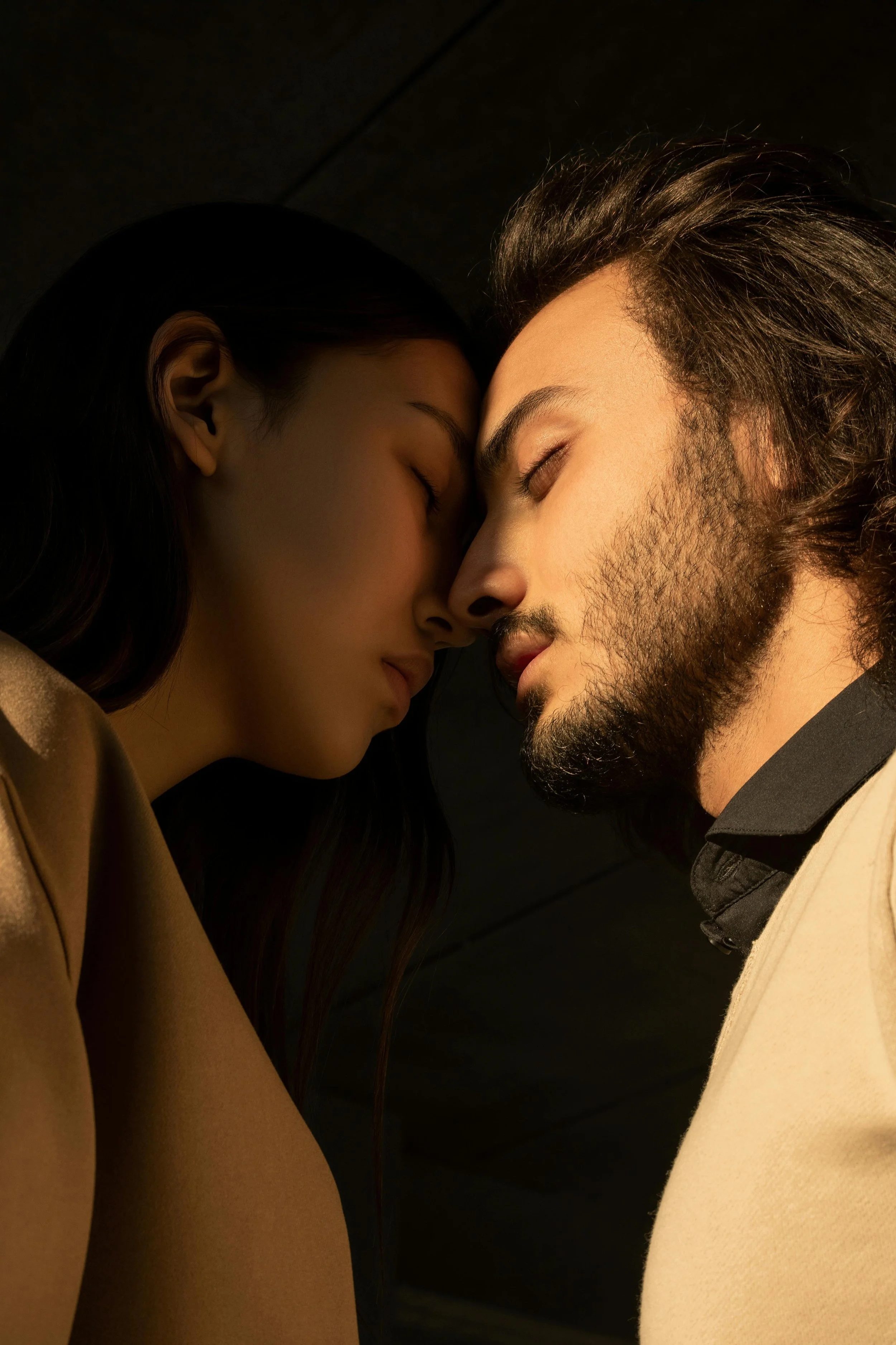 Couple intimately touching face to face symbolizing connection and healing from therapy