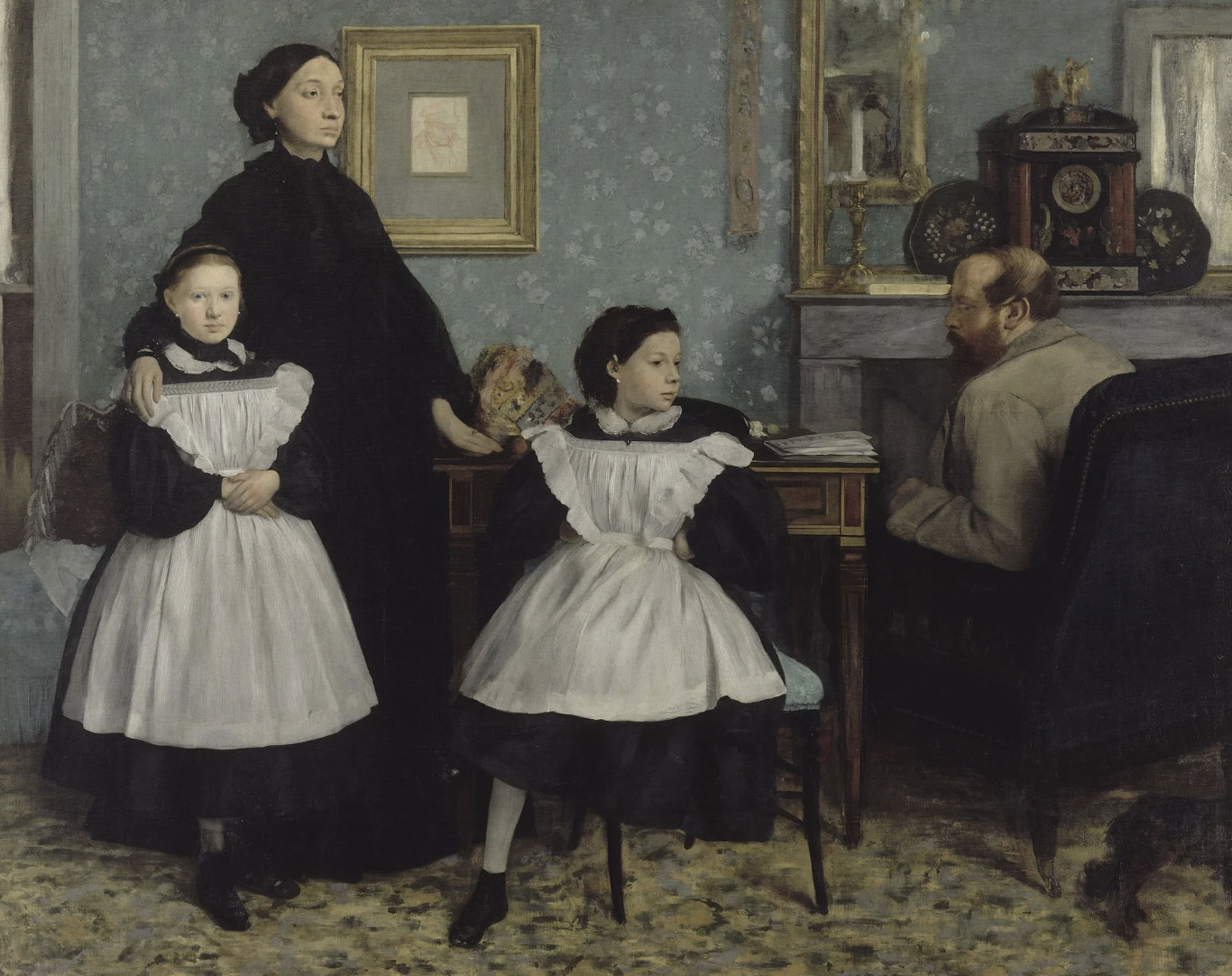 A painting of a family in a room, including a woman and three girls in black dresses with white aprons, and a man with a beard sitting at a desk with folders and papers, with framed artwork and a decorated cabinet on the wall.