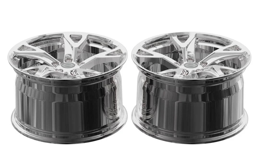 Two shiny silver car rims with intricate spoke designs.