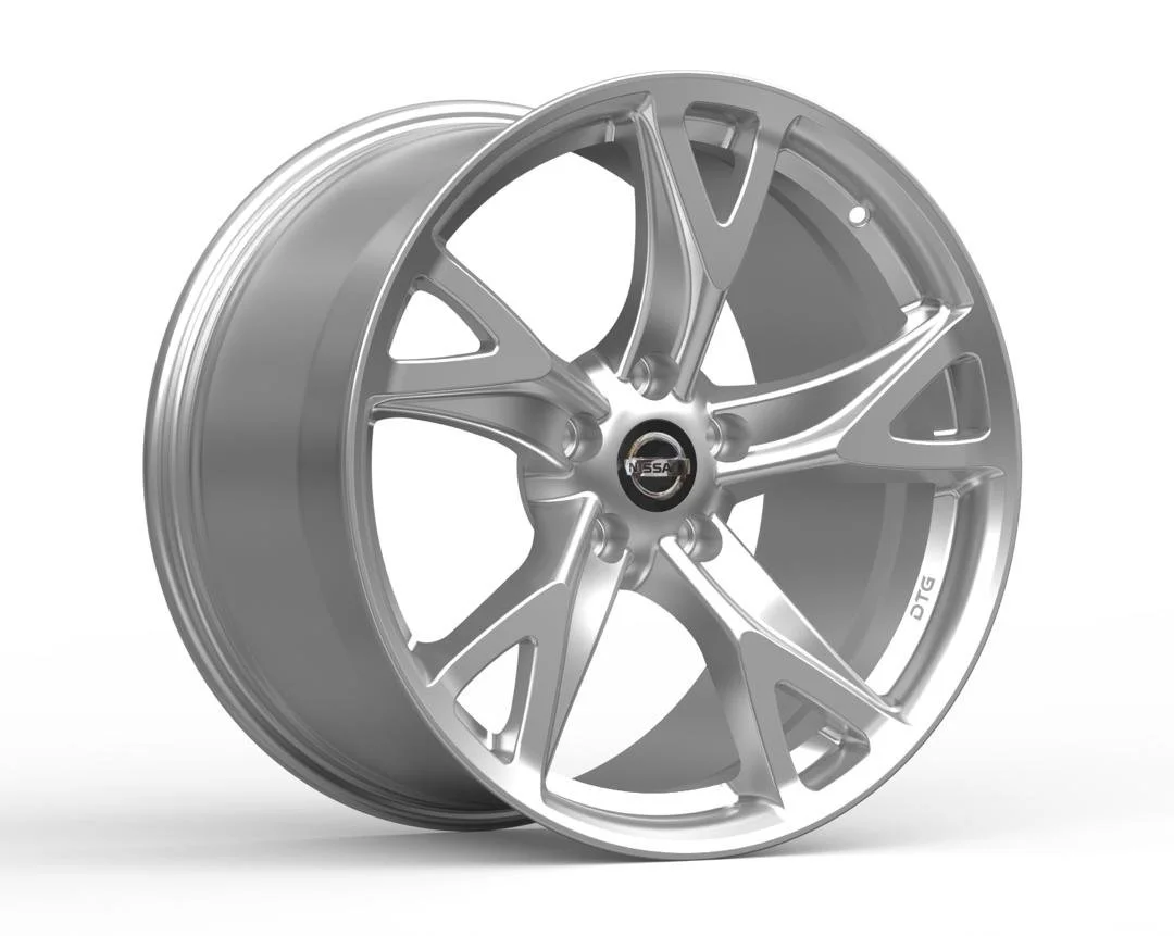 A silver alloy wheel rim with a Nissan logo center cap, designed with multiple spokes and labeled 'DTG'.