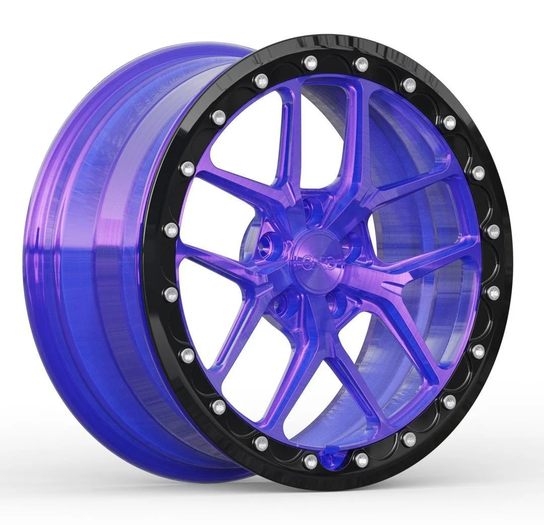 A tire with a purple and blue colored rim and black outer edge with bolts.