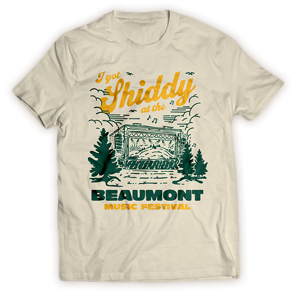 T-shirt with text and graphics promoting the 'Shiddy' music festival in Beaumont. Features a stage, trees, and musical notes in green and yellow.