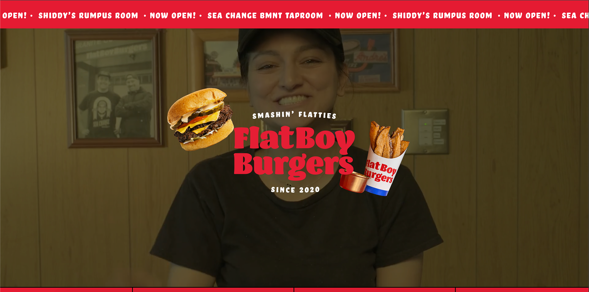 Woman smiling in a wood-paneled room with framed photos on the wall, overlayed with graphics of a burger and fries, and text promoting a restaurant called Flat Boy Burgers.