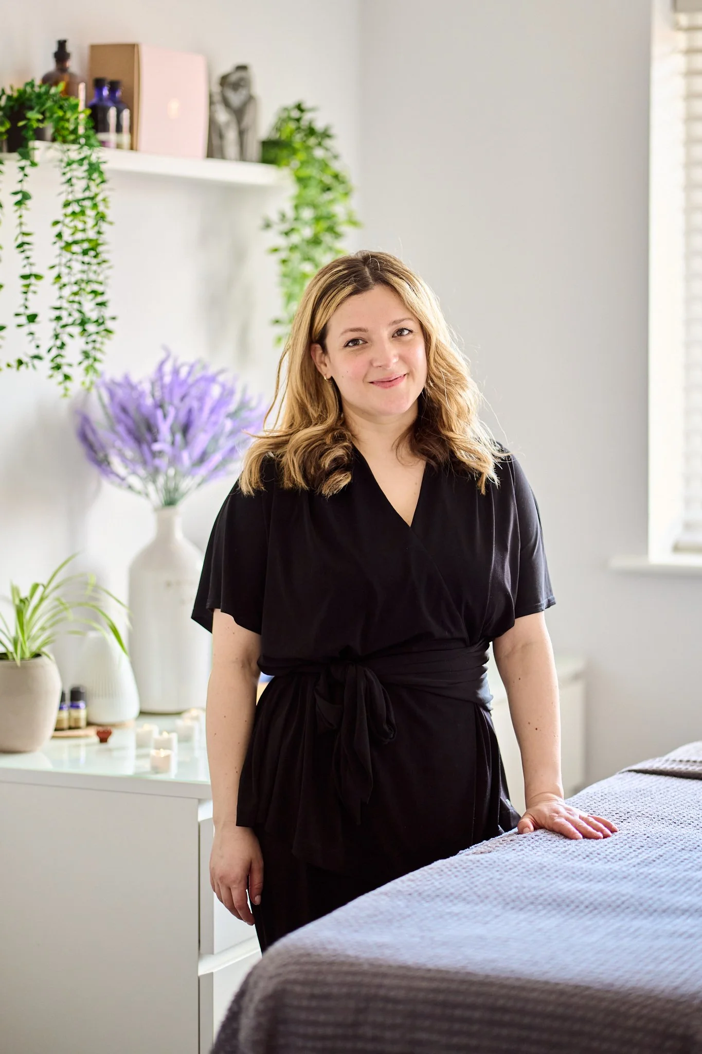 Holistic therapist Gabriella Bloom standing in her calming relaxing home spa in Fleet Facial Massage after working at Pennyhill Park and Coworth and other high end 5star spasfor 20years