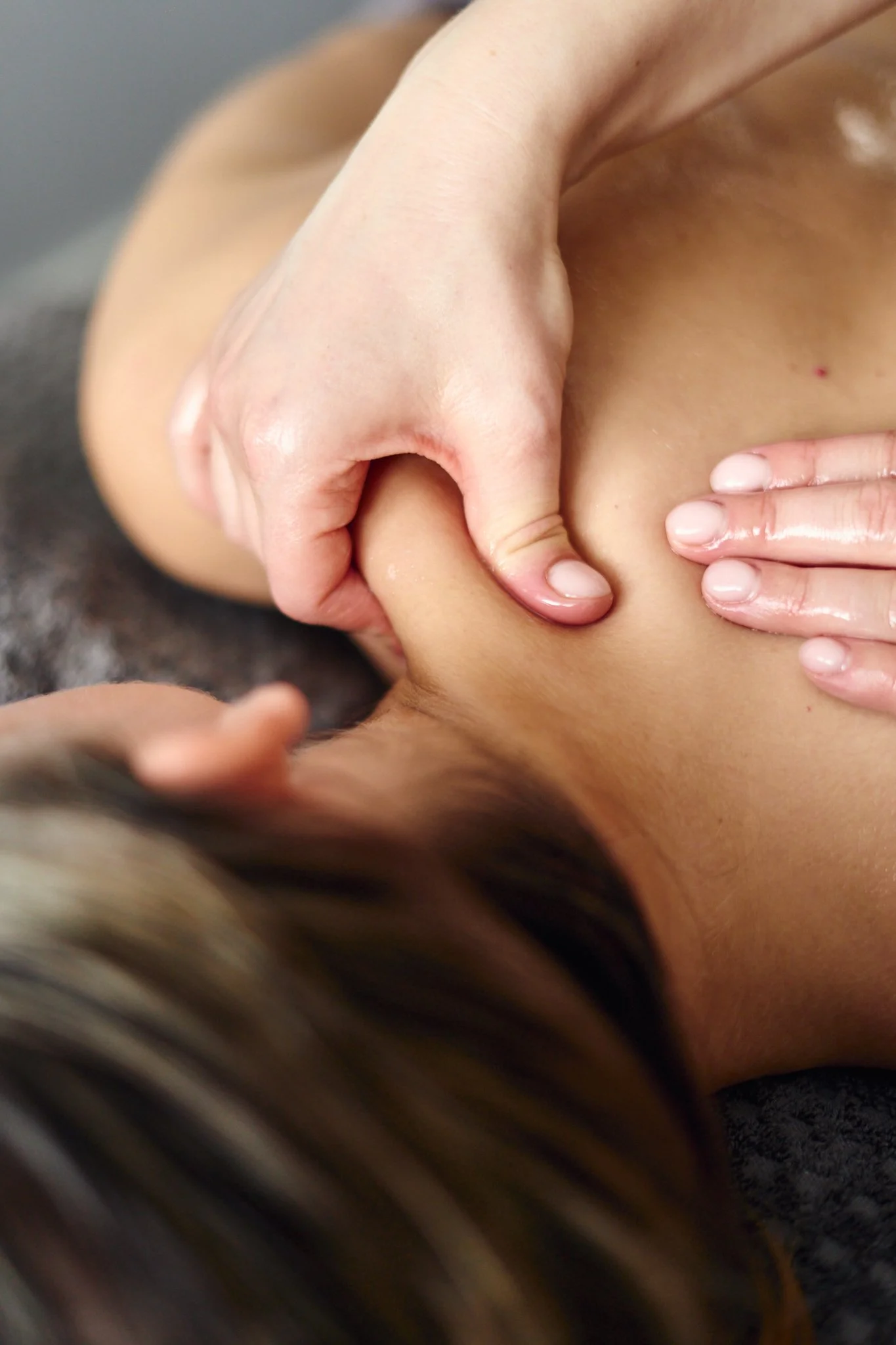 Massage therapist Gabriella Bloom providing a relaxing facial massage in her serene home spa setup in Fleet, Hampshire.