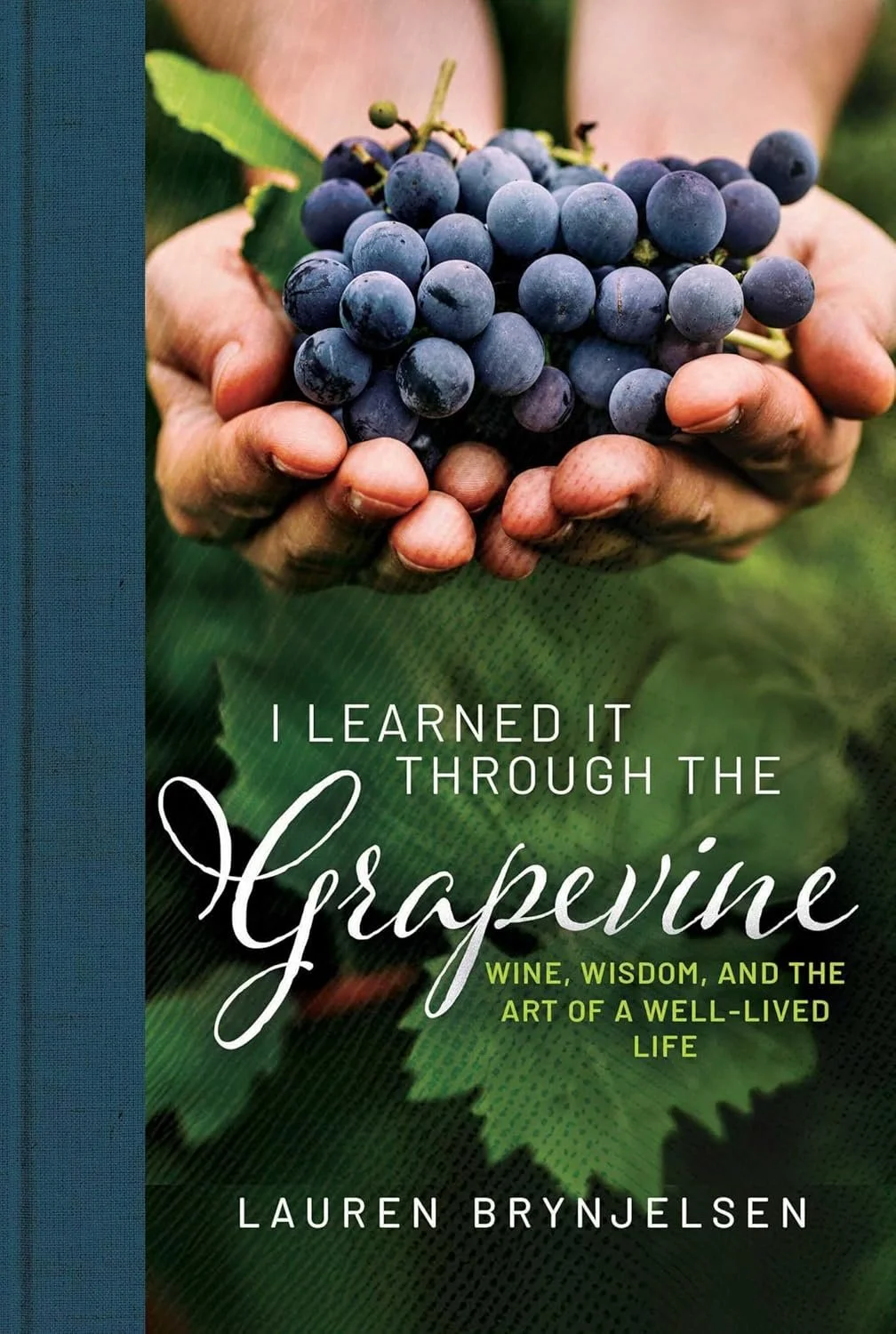 Book cover titled "I Learned It Through the Grape Vine" by Lauren Brynjelsen, showing a close-up of a person holding a bunch of dark purple grapes with green leaves.