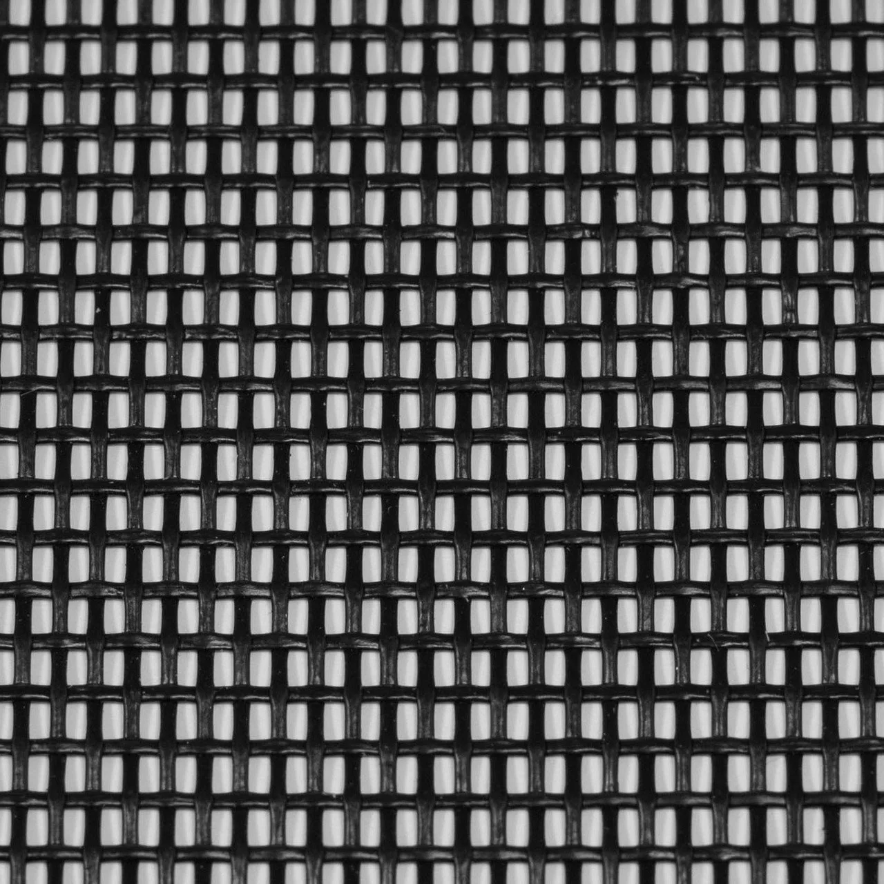 Close-up of black plastic grid with white background