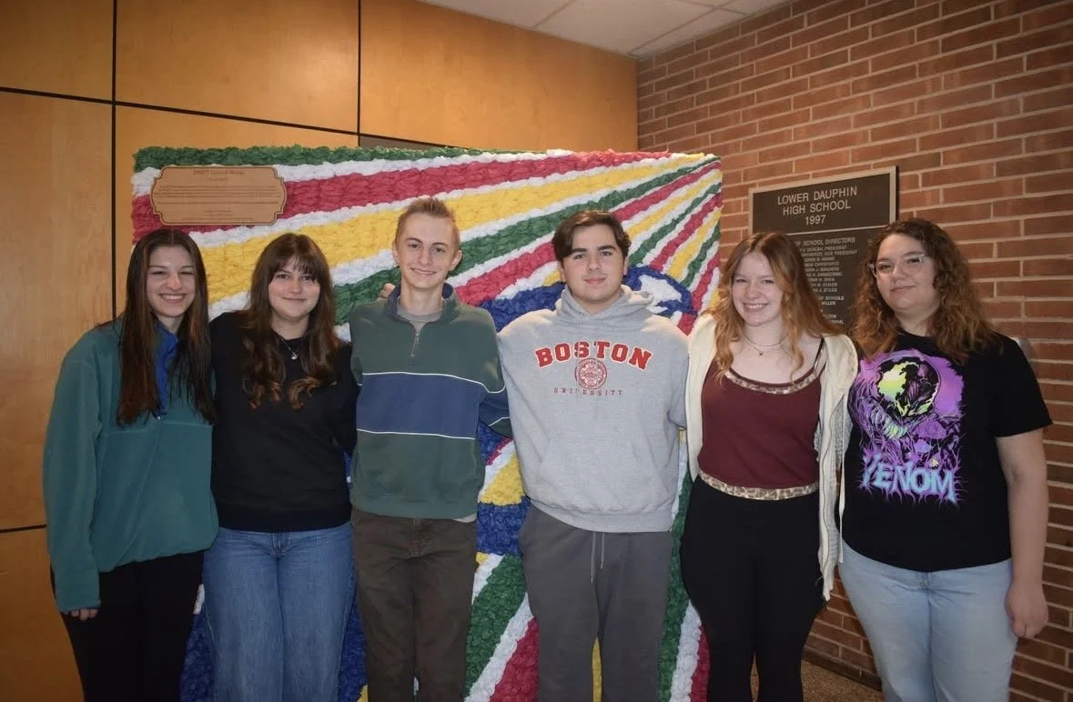 Group of six high school students standing in front of a colorful floral display at Lower Dauphin High School, 1997.