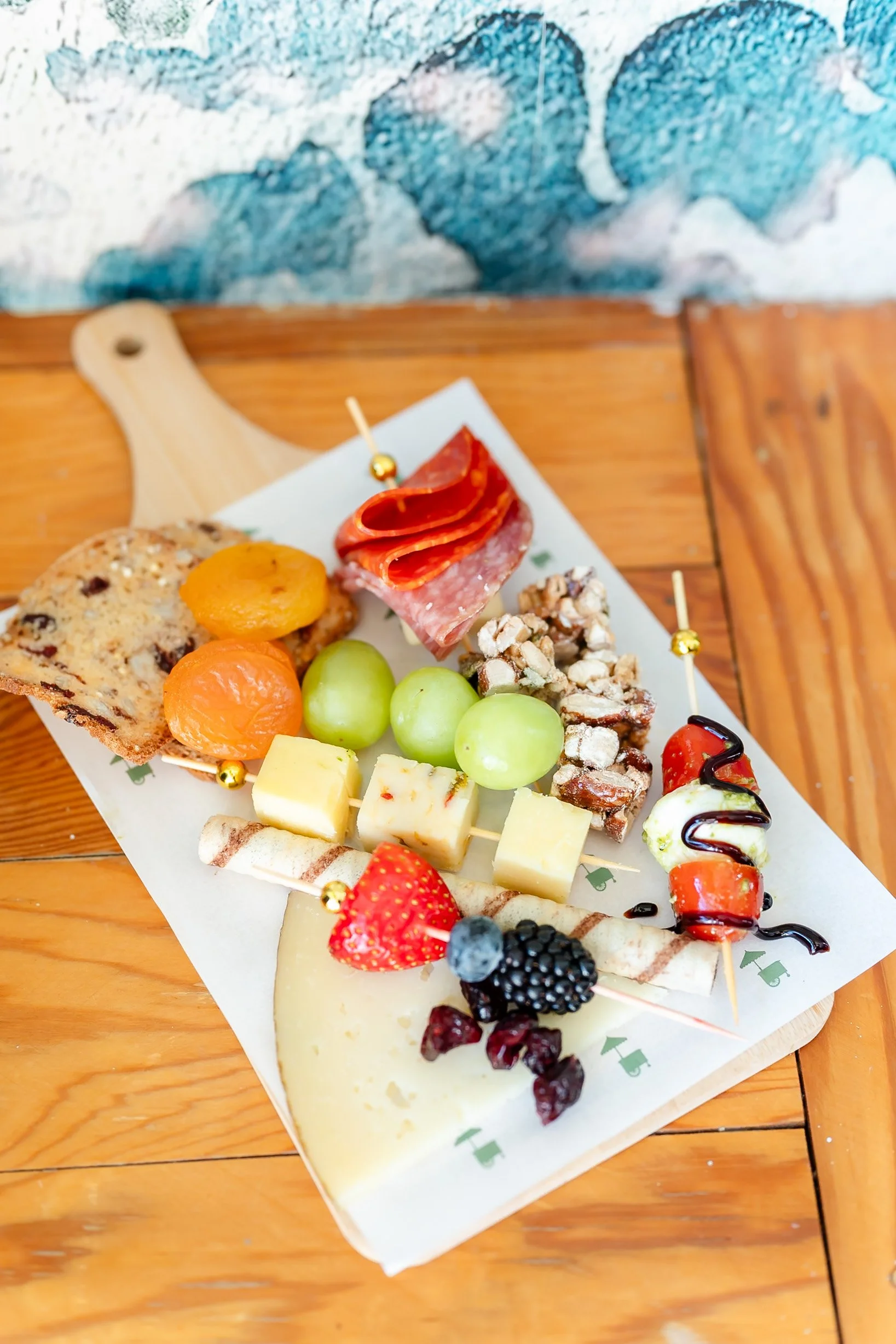 Charcuterie catering display with cheeses, meats, and accompaniments