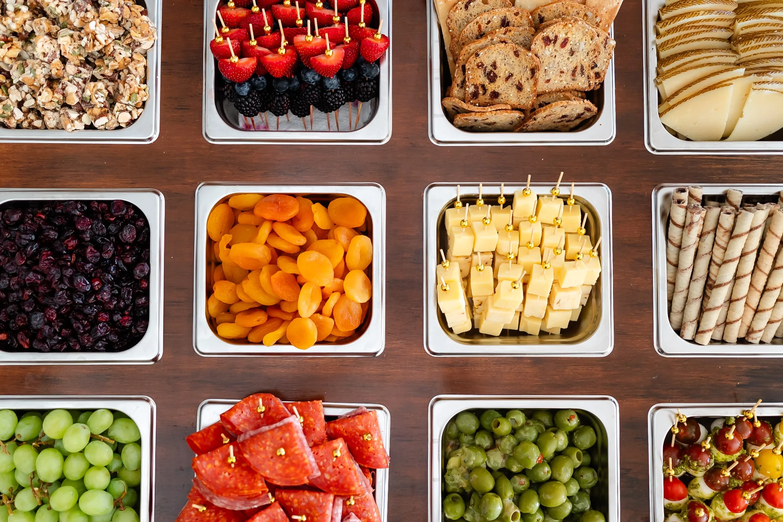 Artisan cheese and charcuterie with fresh fruit and garnishes