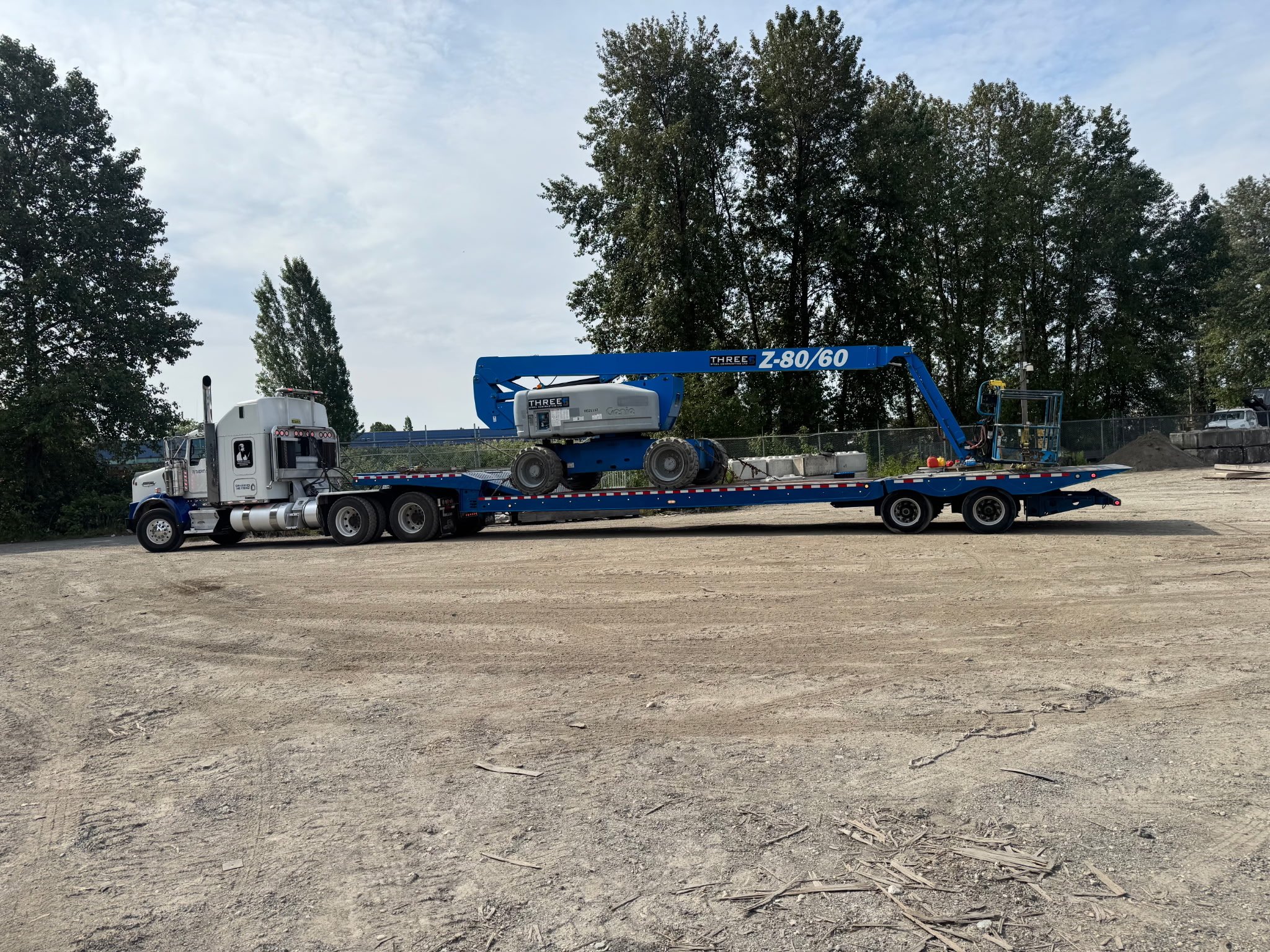 RGN trailer loaded on semi truck