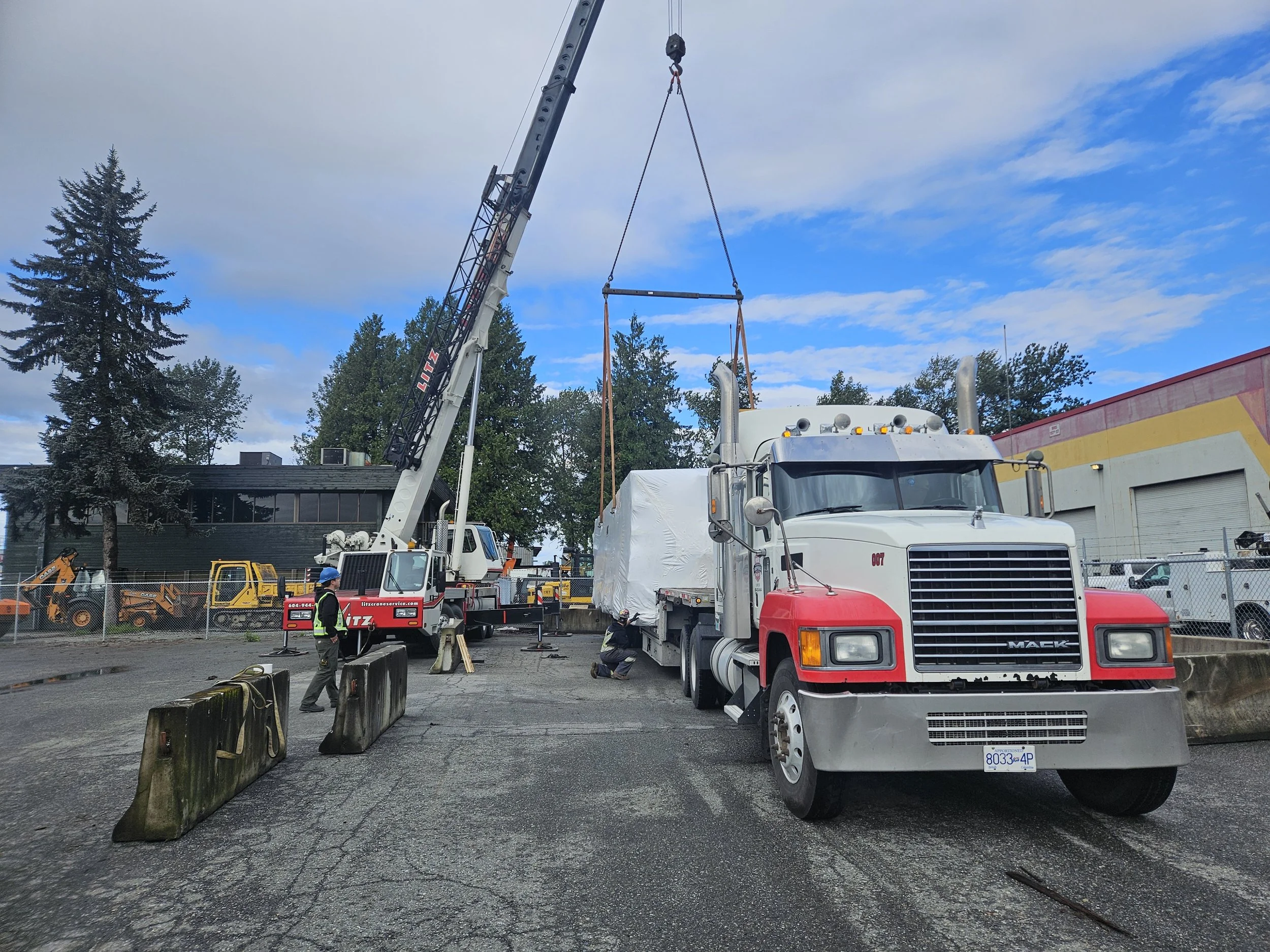 truck offloading by crane at jobsite