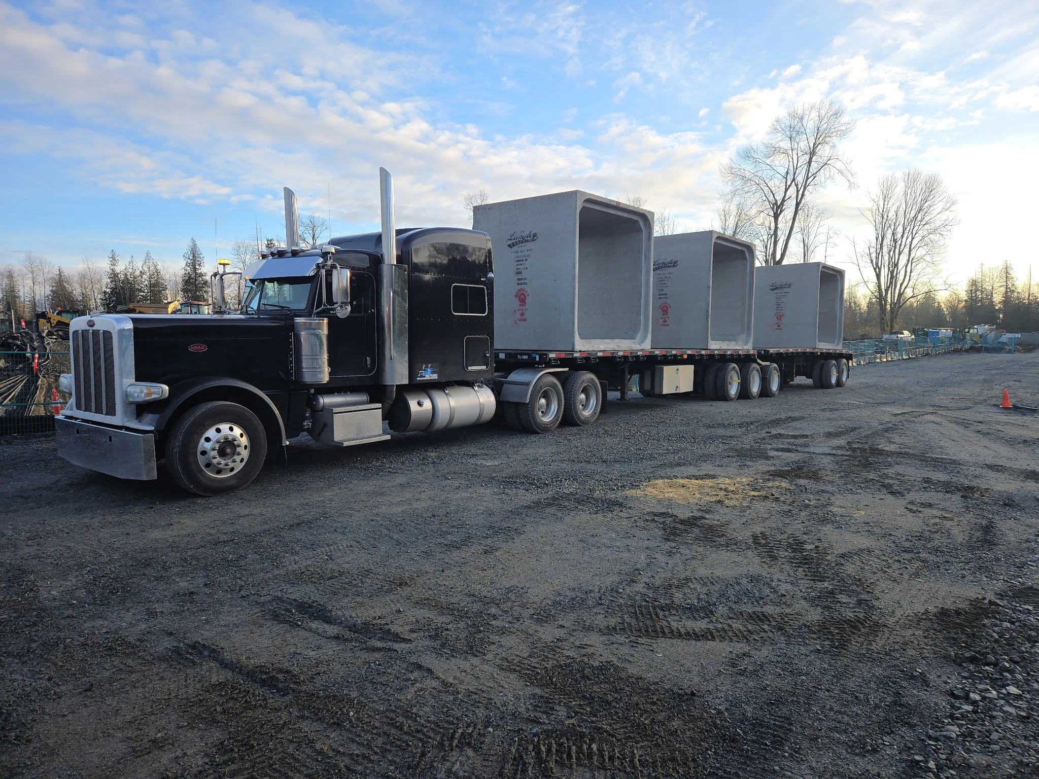 flatbed truck loaded with concrete barriers