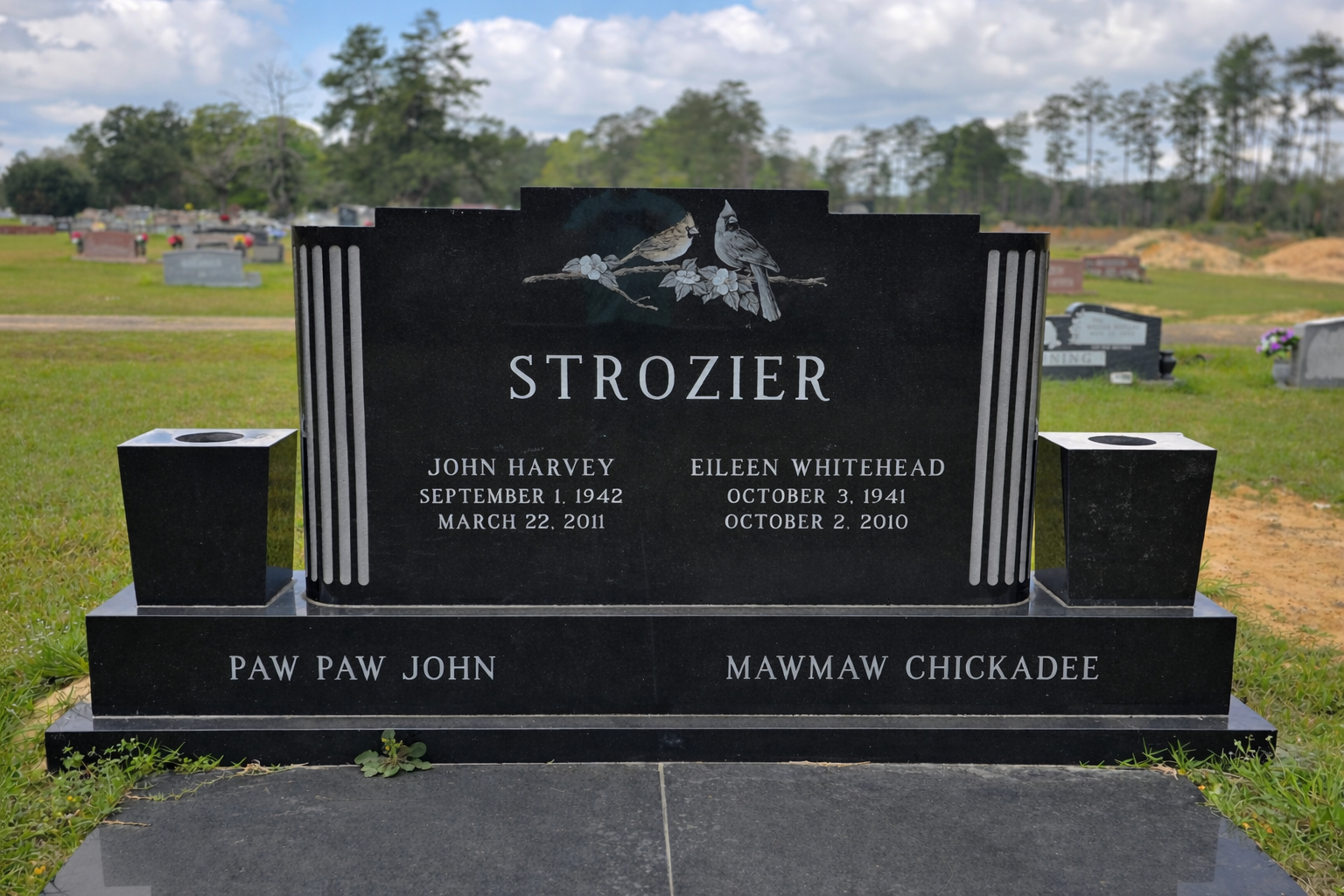 Black granite headstone with two birds on a branch at the top, engraved with the name 'Strozier'. It bears the names John Harvey and Eileen Whitehead, with their birth and death dates, and the names Paw Paw John and Maw Maw Chickadee at the bottom. T