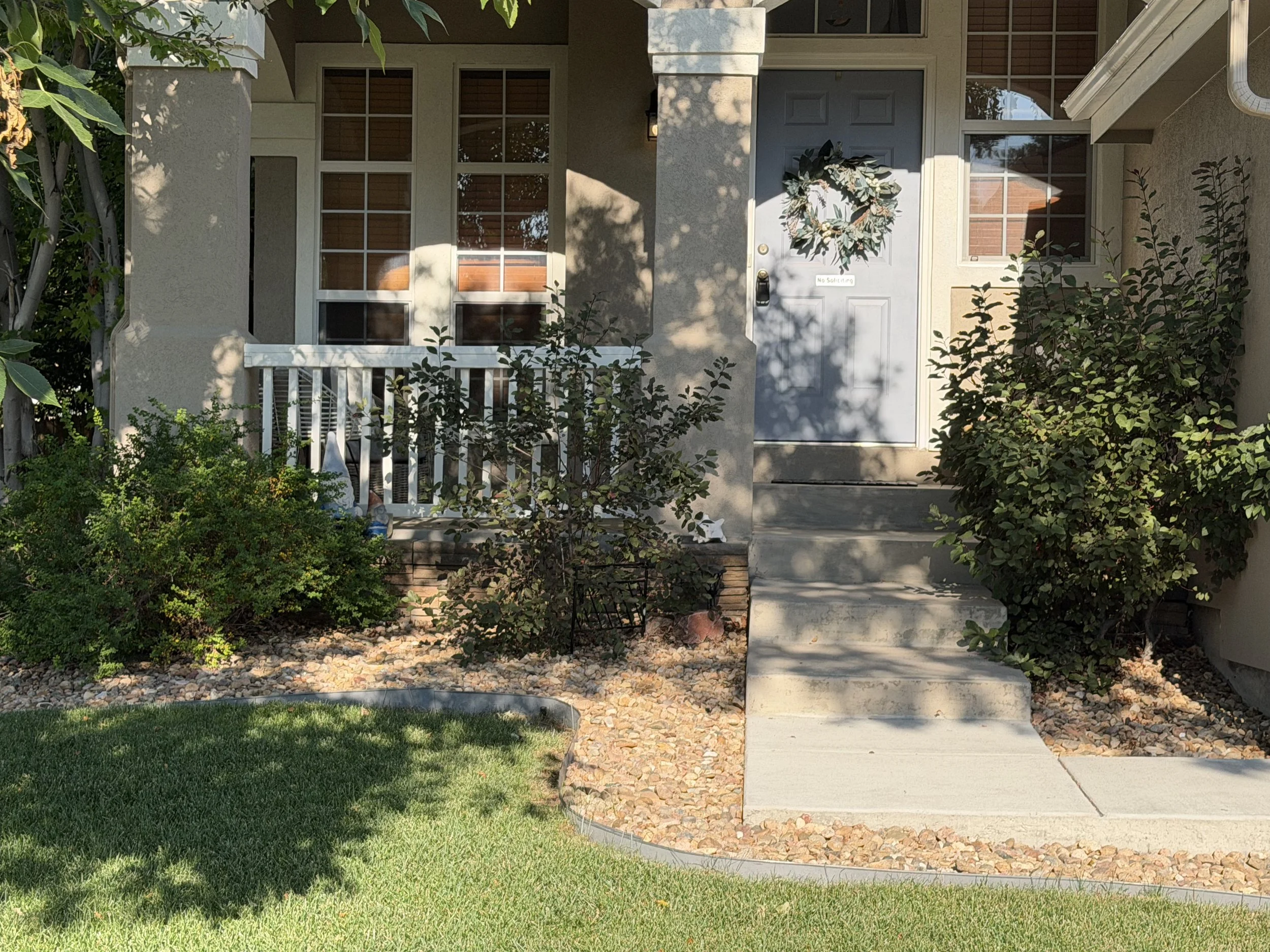 Before: Overgrown shrubs were trimmed and shaped to improve curb appeal, open the walkways, and give the landscape a cleaner, more maintained appearance.