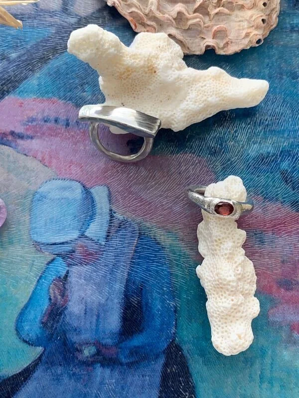 Sterling Silver Rings. One with a garnet stone