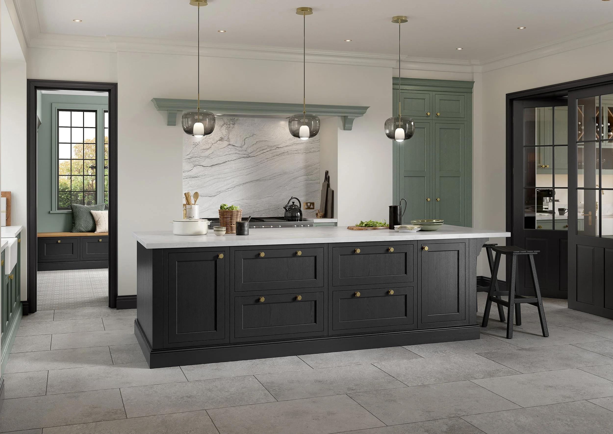 Modern kitchen with black island, green cabinets, marble backsplash, large gray floor tiles, pendant lights, and a small seating nook with a window.