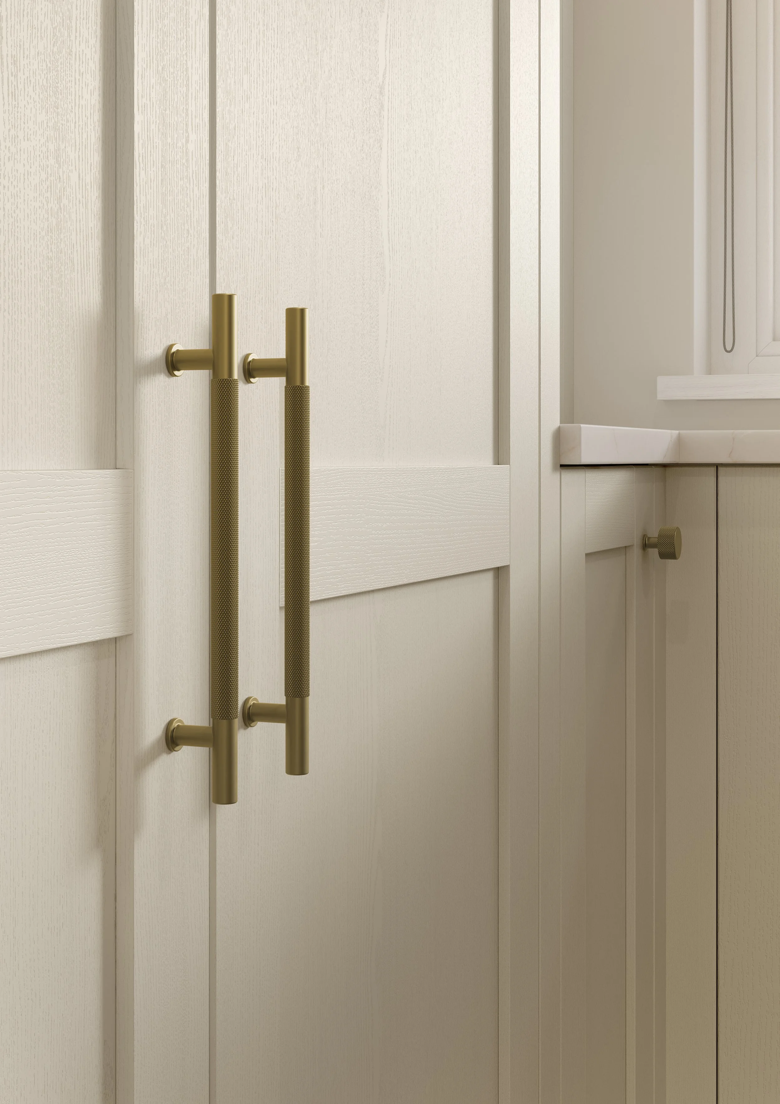 Close-up of brass door handles on white paneled door, with a window and chain curtain in the background.