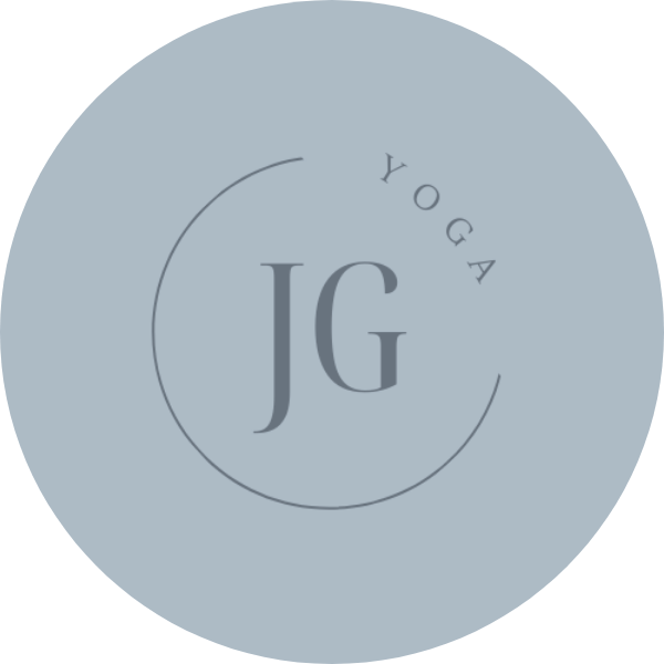 A circular logo with a light blue background, featuring the large initials 'JG' in the center, and the word 'YOGA' curved above them.