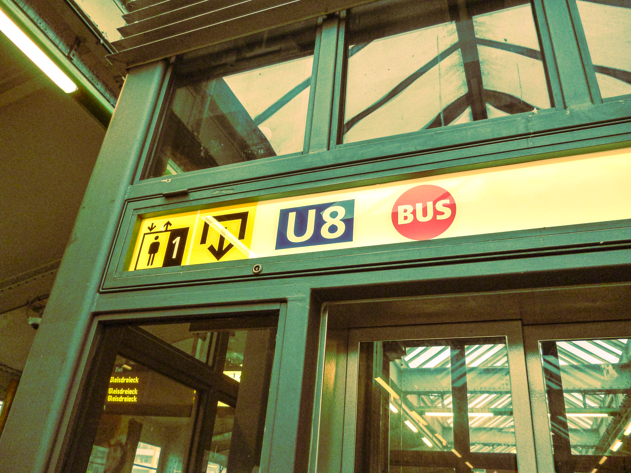 Sign showing elevator, escalator, U8 subway line, and bus at transit station