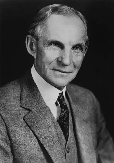 Black and white portrait of a middle-aged man in a suit and tie, with neatly combed hair, looking slightly to the side.