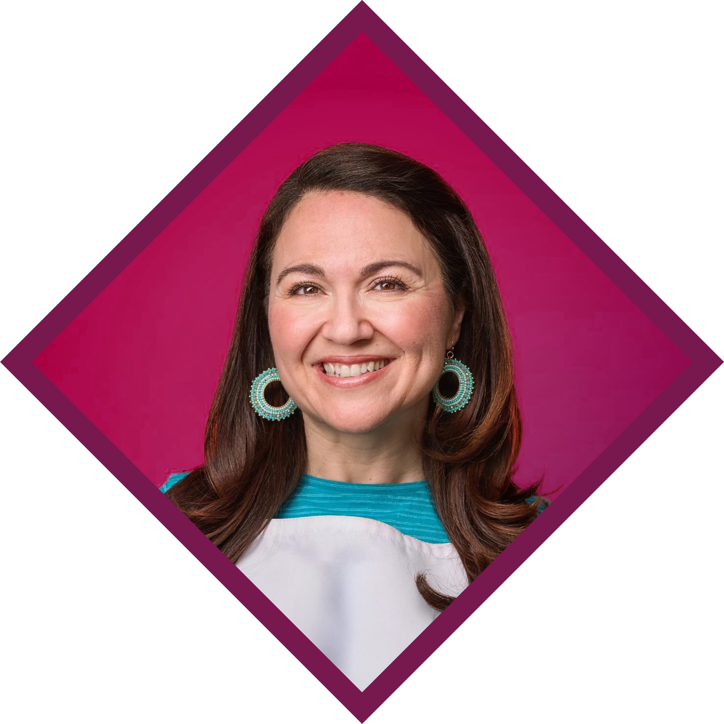 Close-up of a smiling woman with long brown hair wearing turquoise earrings and a striped shirt against a pink background with geometric design.