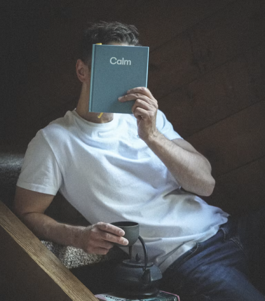 A man holding a Book entitled Calm.