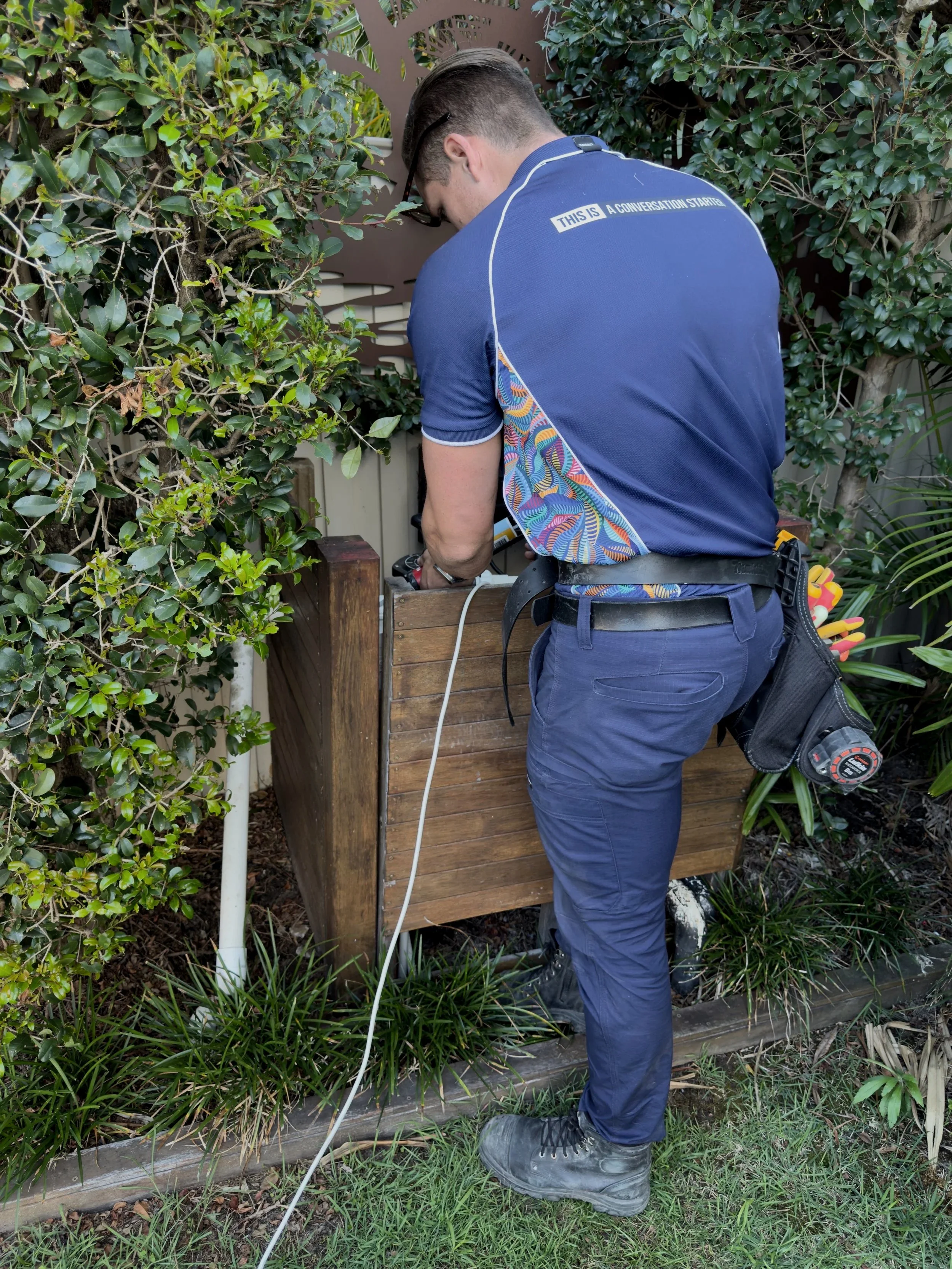 Electrician performing outdoor electrical repair and installation in Brisbane residential property