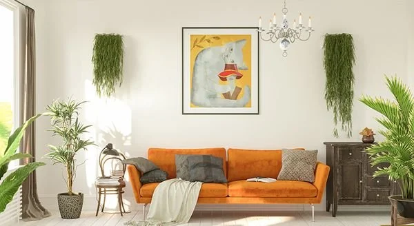 Living room with orange sofa, gray and patterned pillows, green plants, framed artwork of a bear with a hat, chandelier, and vintage dark wood cabinet.