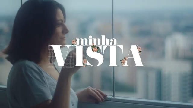 A woman looking out a window with the words 'minha vista' overlaid