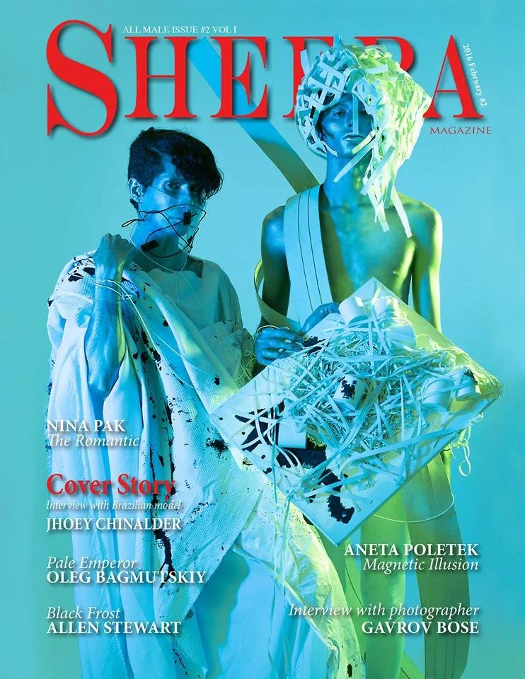 Front cover of Shemera magazine featuring two models with artificial, futuristic clothing and accessories, set against a blue background.