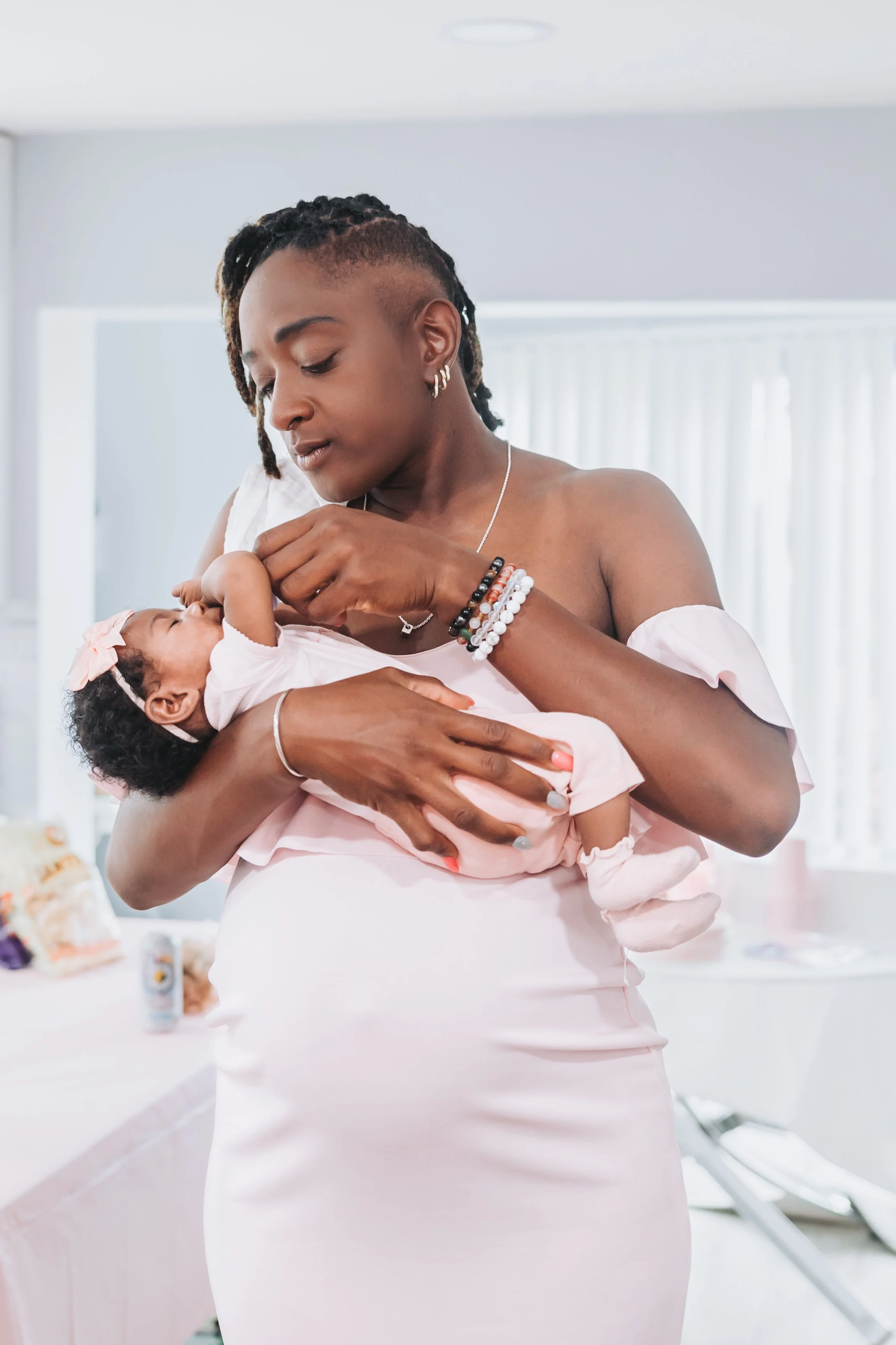 A mother holding her baby in a softly lit portrait photographed by Saint Charles CL.