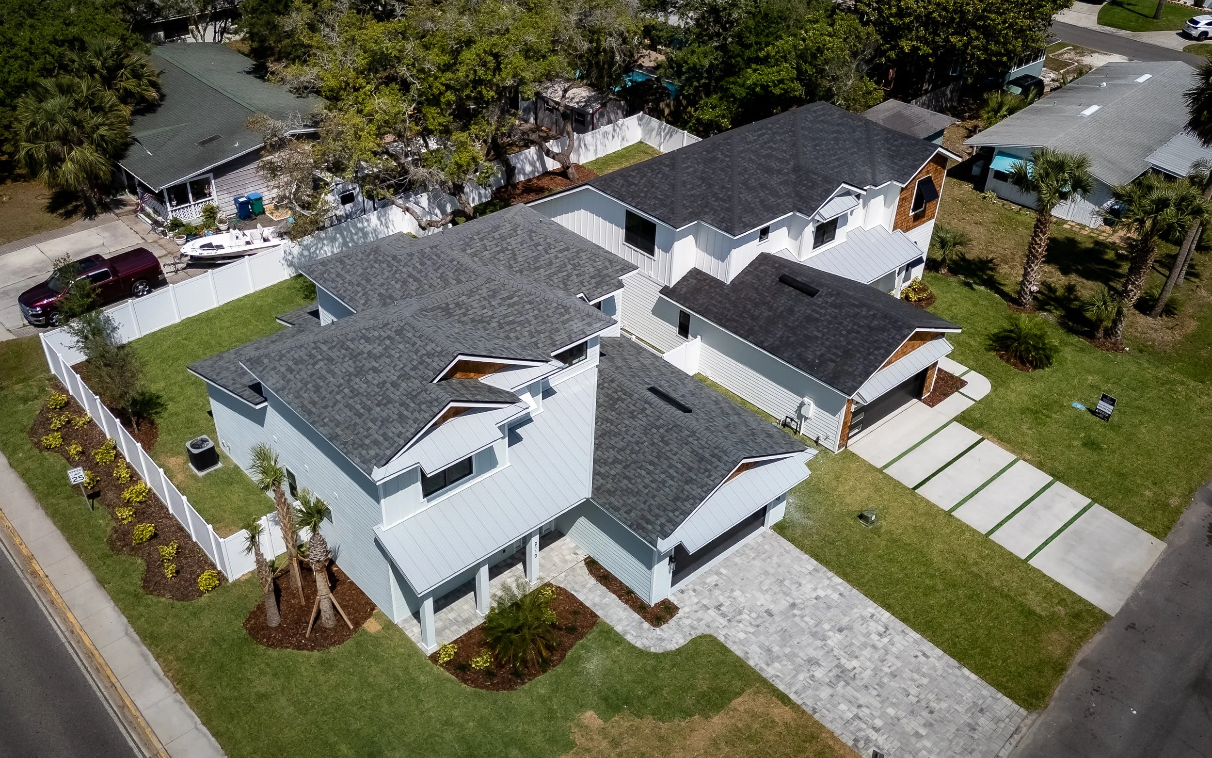 Aerial view of high-quality roof replacements in a Jacksonville residential neighborhood.