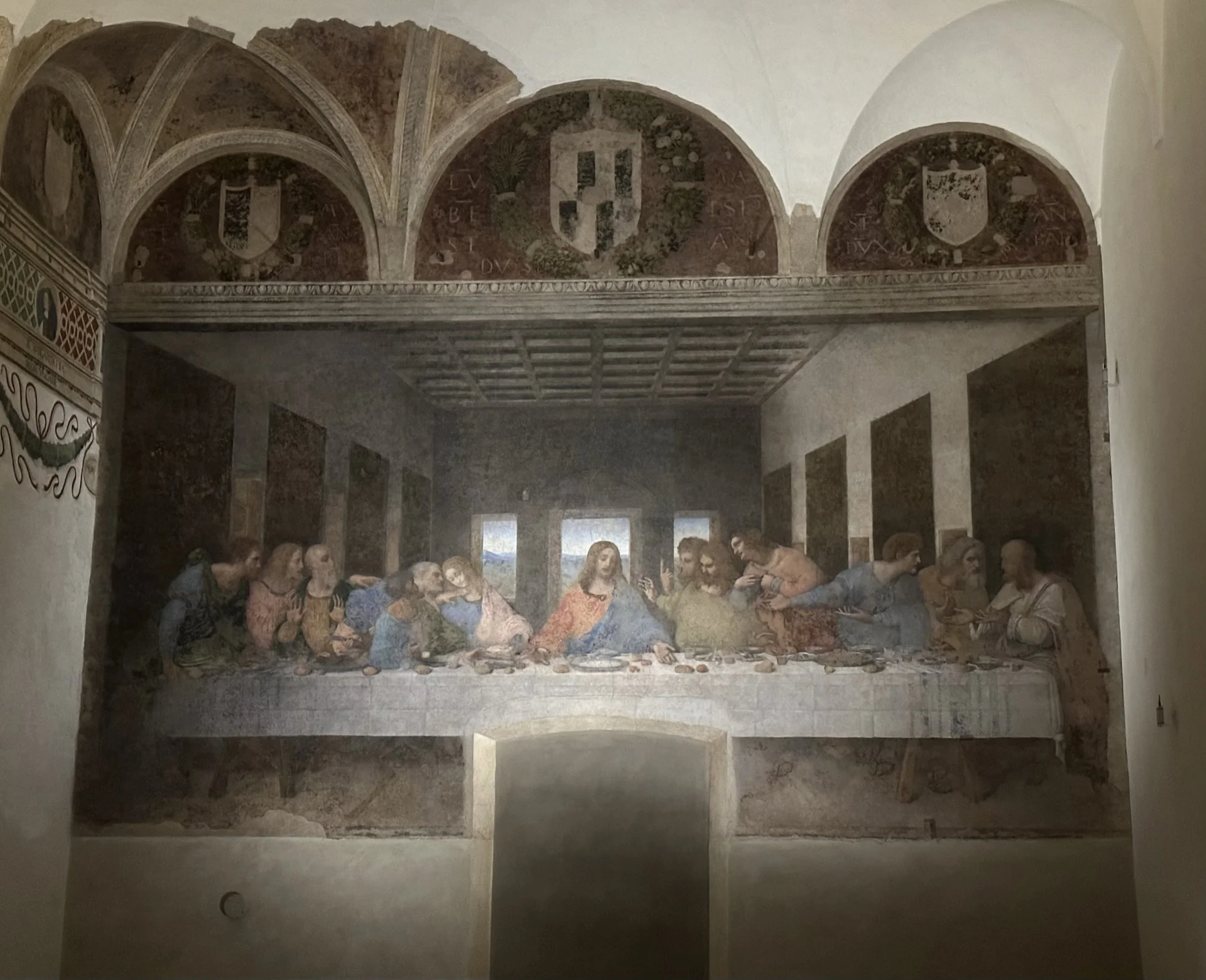 Fresco painting of The Last Supper, with Jesus and his disciples sitting at a long table, in a classical art style.