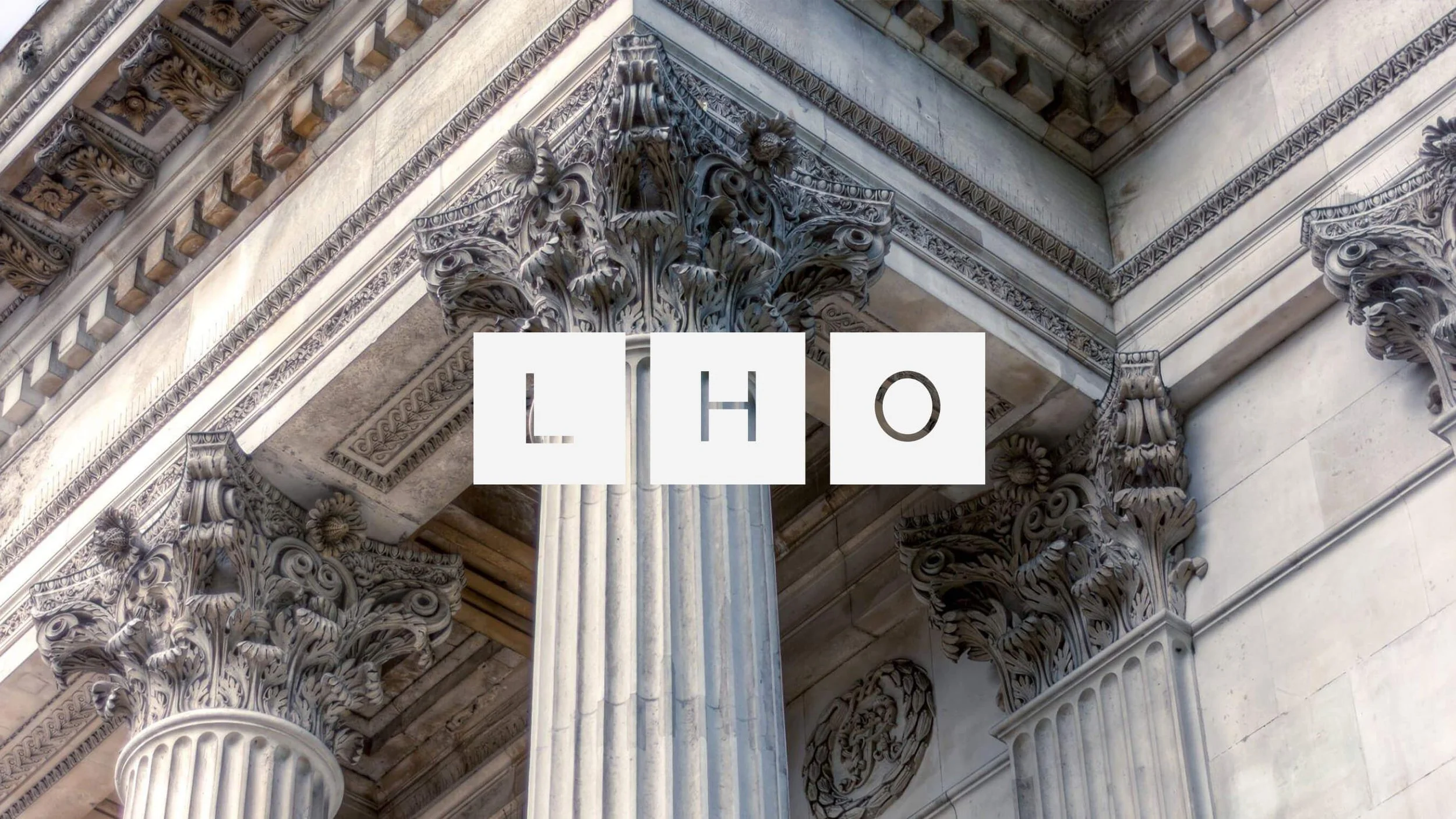 Law firm logo lettering photographed against classical architecture