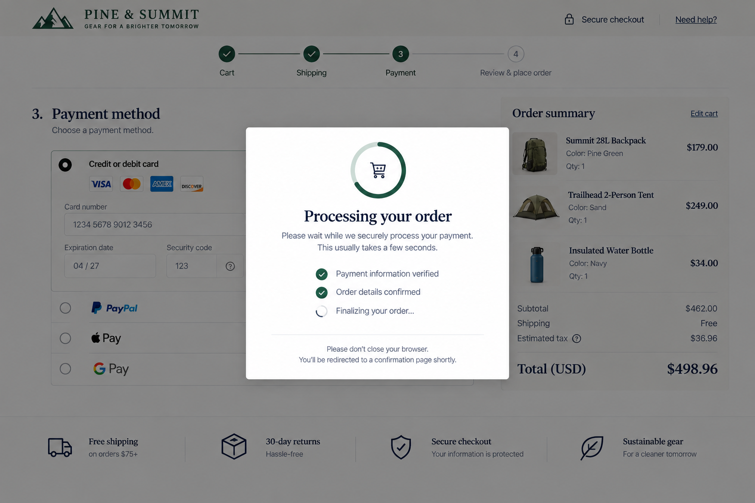 Overlay window showing order processing with checkmarks indicating payment verification and order confirmation, while the background shows an online shopping checkout page for outdoor gear including a backpack, tent, and water bottle, with total cost $498.96.
