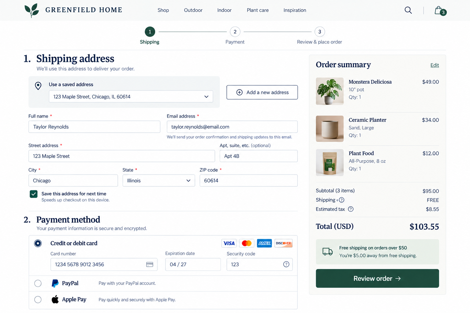 Screenshot of an online shopping checkout page from Greenfield Home, showing shipping address, payment method options, and order summary with three items: a Monstera Deliciosa plant, a ceramic planter, and plant food, totaling $103.55.