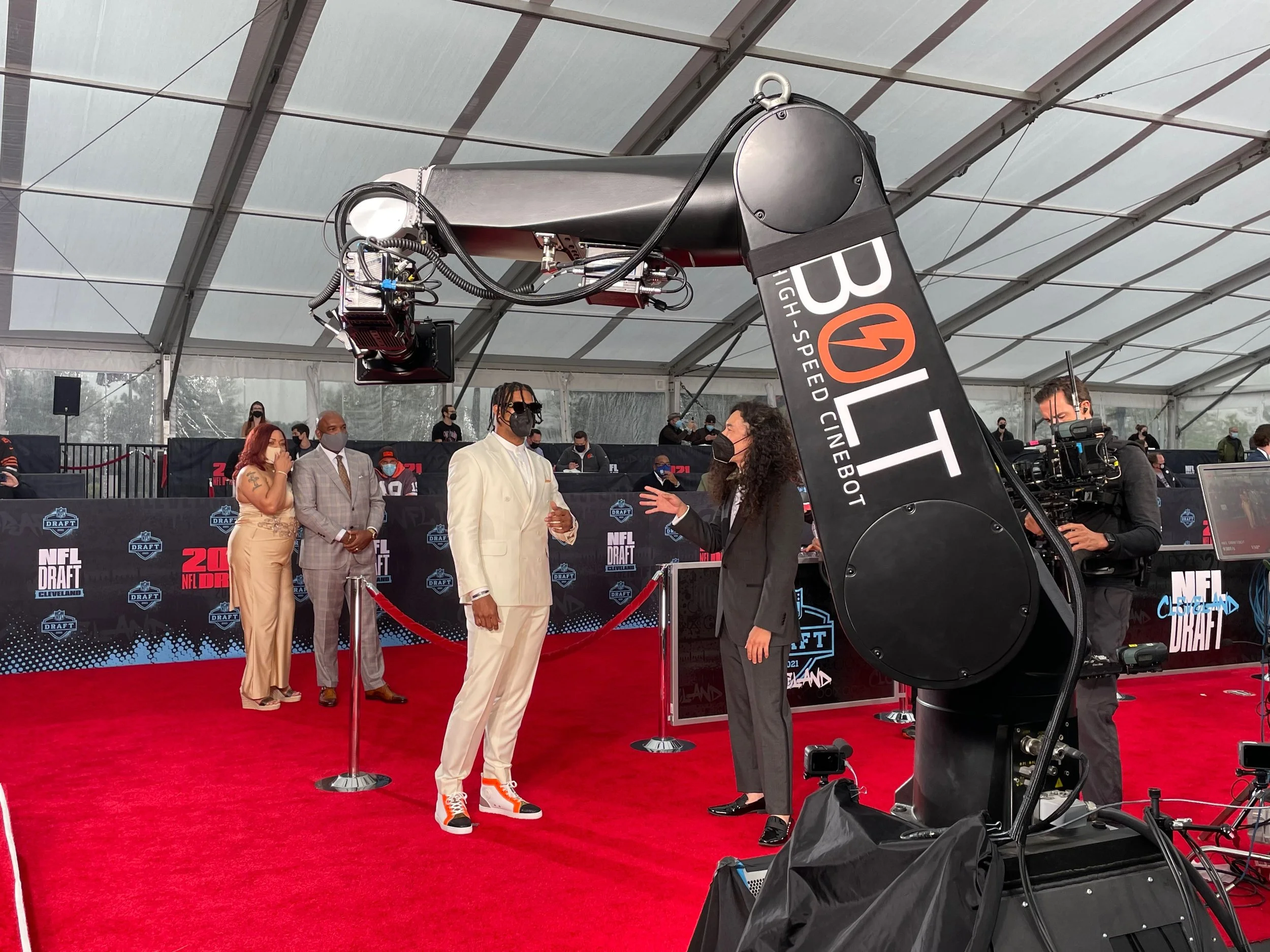 People on the red carpet at the NFL Draft with a camera crane overhead