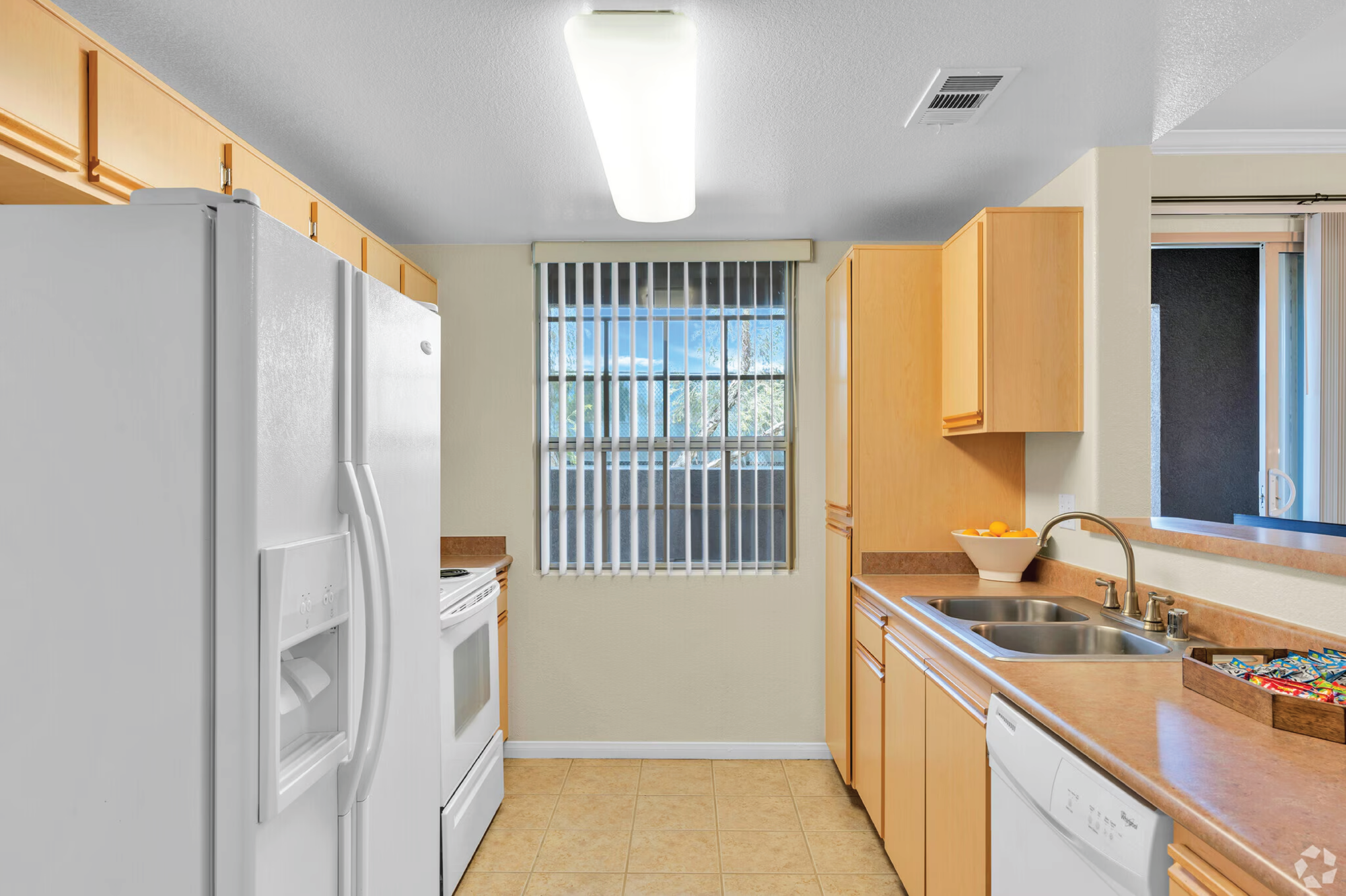 A One-Bedroom Apartment at The Enclave. This is a photo of the kitchen. 