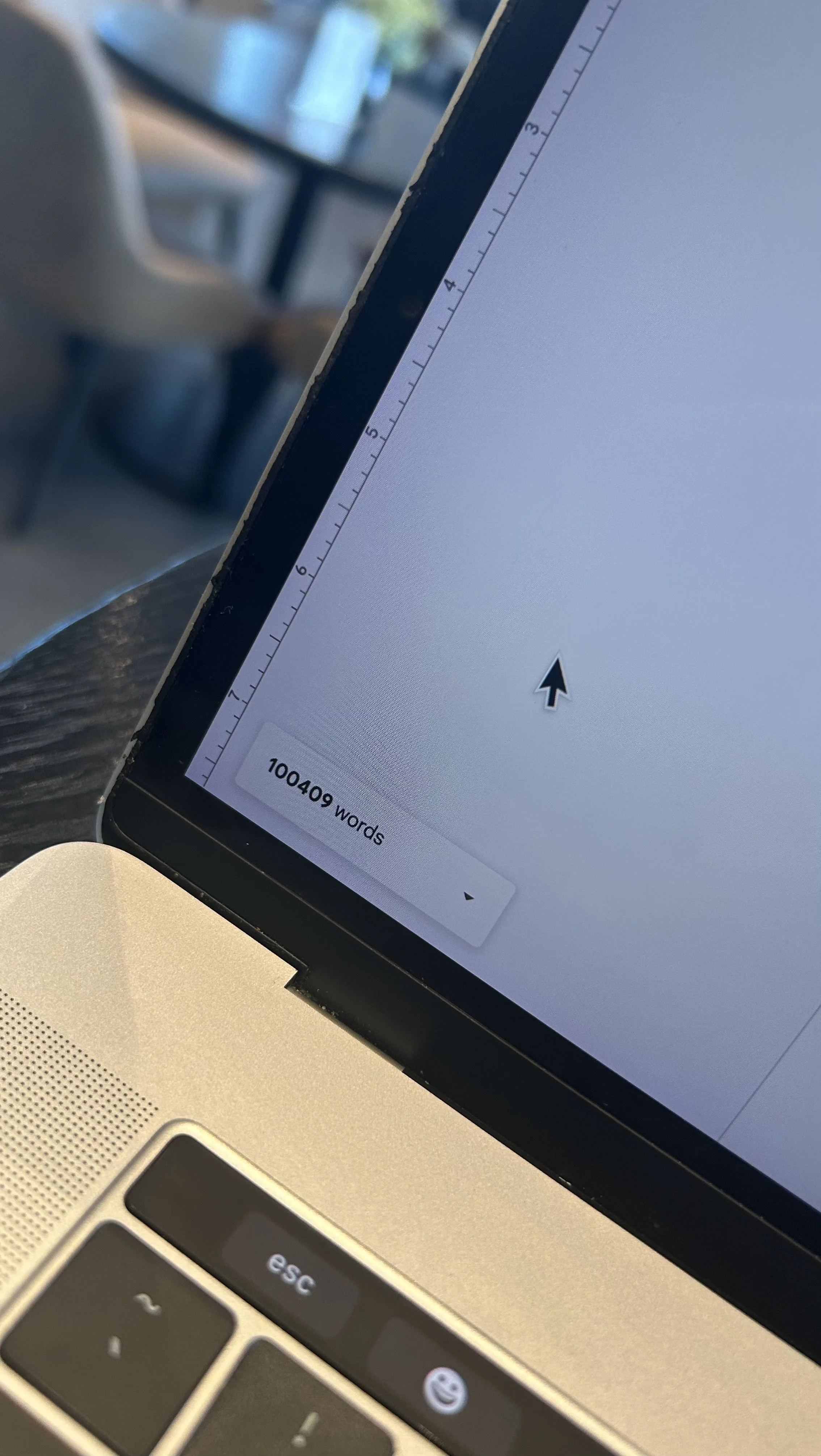 Close-up of a MacBook screen showing a document or writing app open with a word count of 10,040 words in the bottom left corner; the keyboard and part of the trackpad are visible.