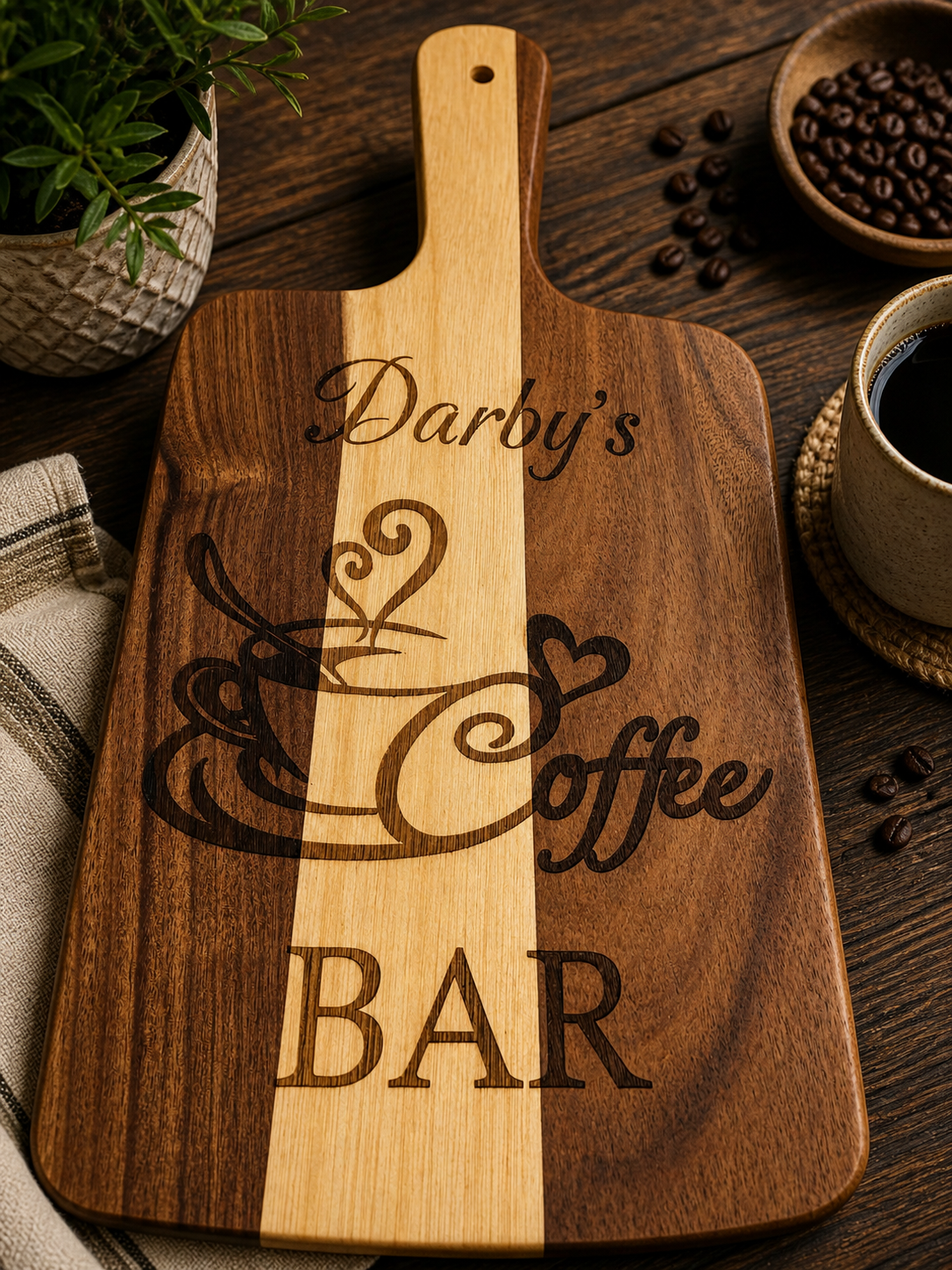 Wooden coffee bar serving board with the words 'Darby's Coffee Bar' and a steaming coffee cup illustration, surrounded by a cup of coffee, coffee beans, and a potted plant.