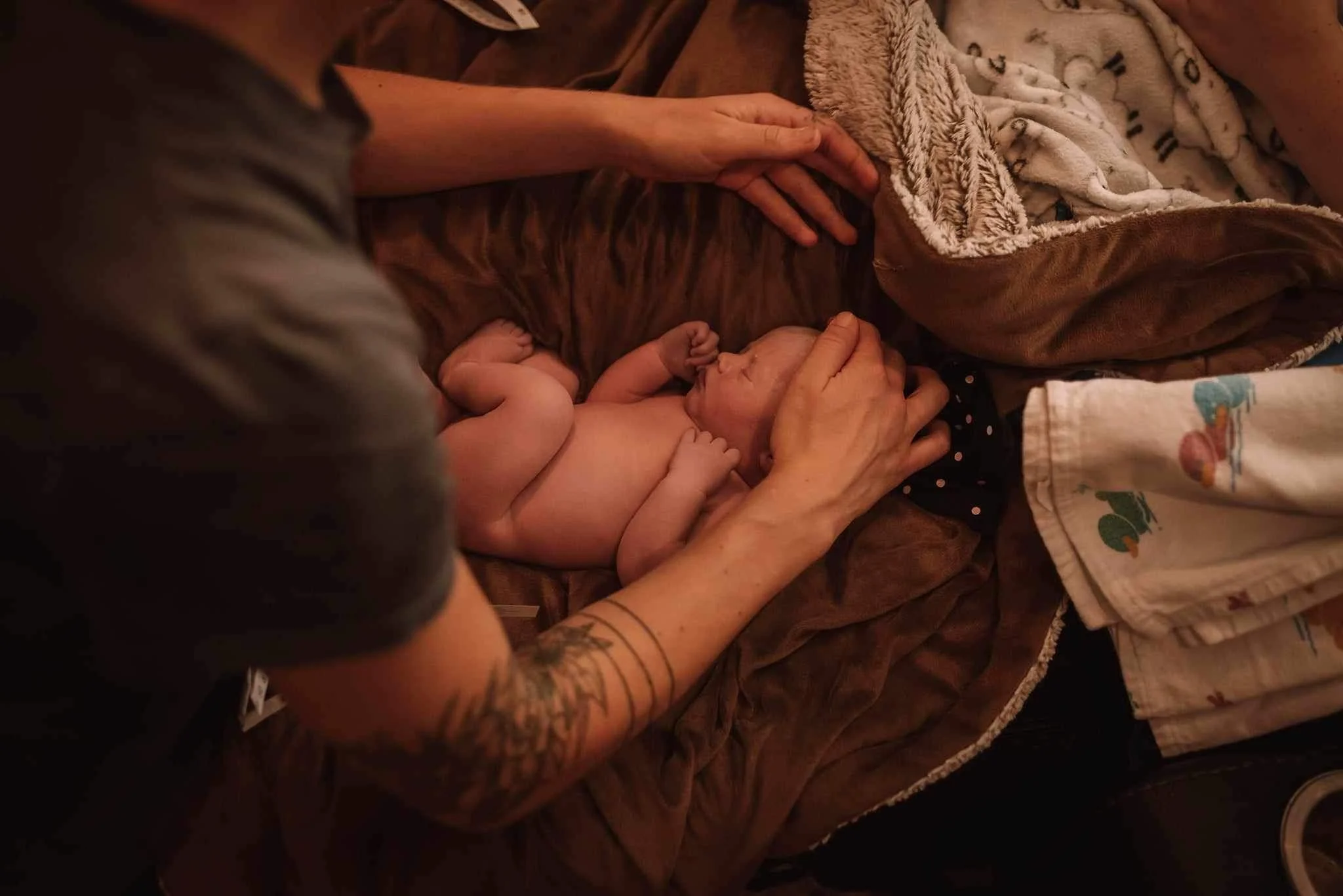 Midwife gently performing a newborn exam